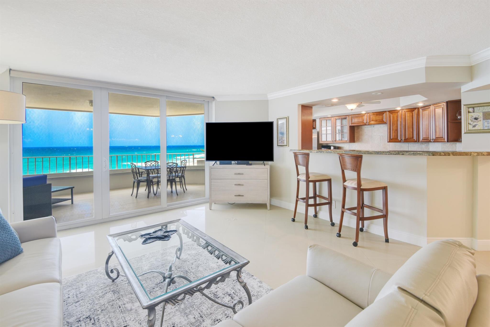 Experience luxury coastal living in this bright and airy 2BD/2BA residence on the 5th floor, offering breathtaking ocean views from every room. Enjoy the sound of the waves and sea breezes from your large terrace overlooking the Atlantic Ocean.The open, custom kitchen flows seamlessly into the living and dining areas, perfect for entertaining. Beautiful porcelain floors extend throughout, adding a sleek, modern touch.This full-service, luxury building sits directly on the sand and features a newly renovated lobby, private beach access, resort-style pool and hot tub, state-of-the-art fitness center, and two tennis courts. Additional amenities include 24-hour manned security, barbecue areas, and covered parking. Prime location--just a short walk to the Boca Raton Beach Club and fine dining.