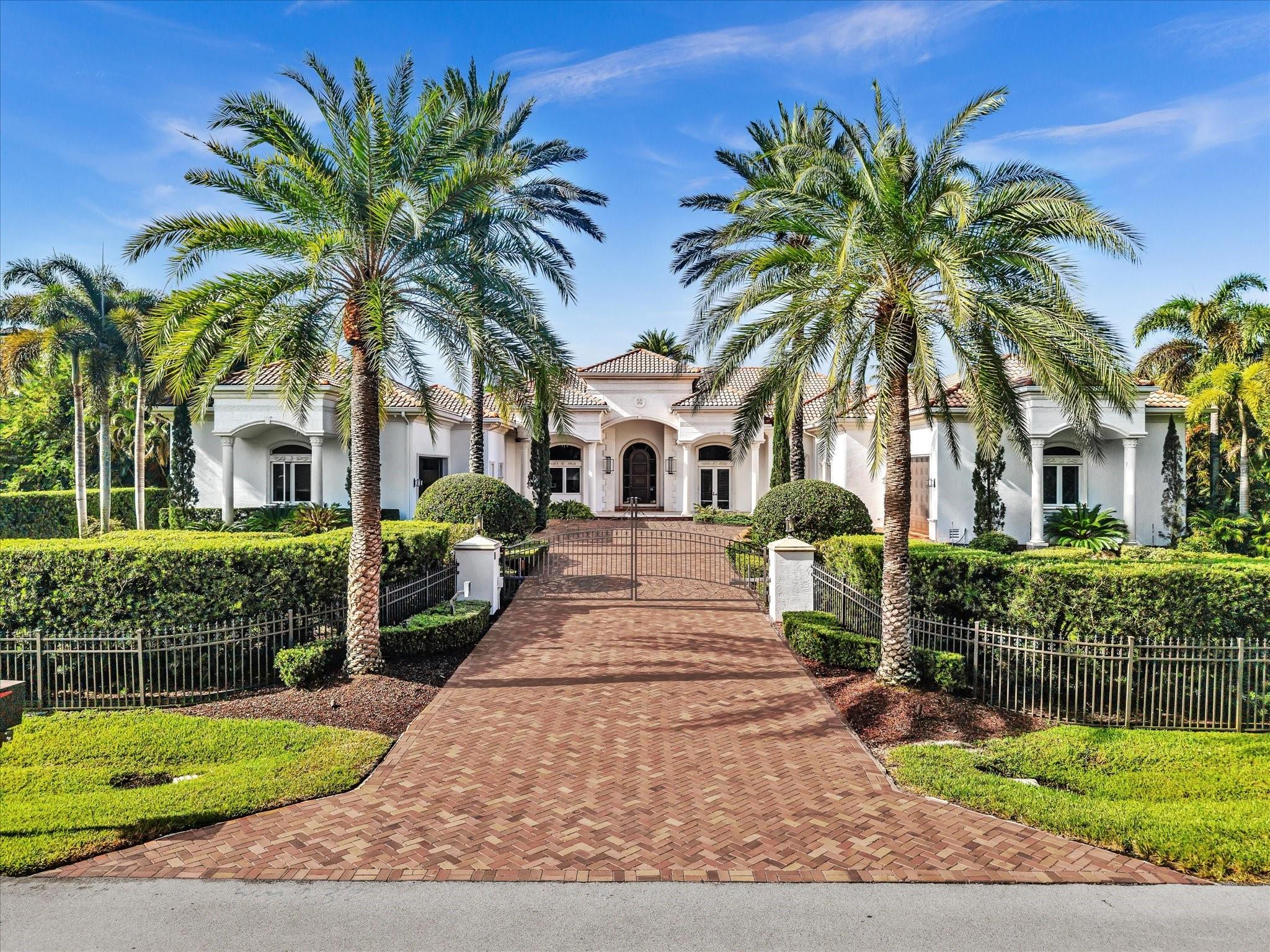 Behind a lush wall of Areca Palms, this 7-bedroom, 8.5-bath estate on 1.22 acres offers the rare blend of privacy, luxury, and space. With 6,842 sq ft under soaring 14-ft ceilings, every detail is built for elevated living.
The chef’s kitchen features Sub-Zero refrigeration, Wolf appliances, and custom storage. A Control4 smart system, projector-equipped media room, and en-suite baths in every bedroom ensure effortless comfort. The primary suite boasts dual “hers” closets and a spa bath with two private toilet rooms and Toto Washlets.
Outdoors, enjoy a heated pool and spa, koi pond, summer kitchen, guest house, and whole-home generator — all behind a gated entry.
It's time to experience the pinnacle of Plantation Acres Living