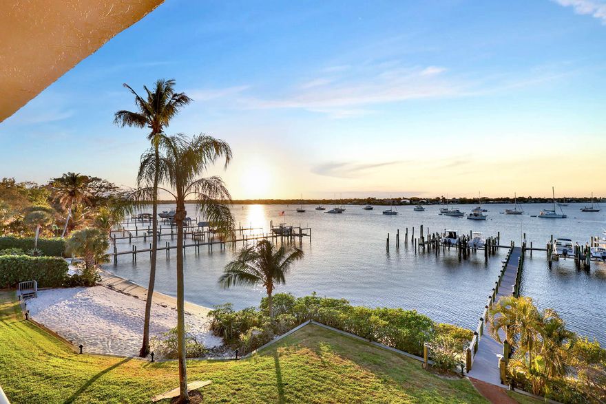 RARE opportunity! Highly sought-after Edgewater Condo, this beautifully appointed 2-bedroom + office, 2-bath residence offers timeless finishes and expansive SUNSET views over the St. Lucie River from a 45-foot balcony. Rich hickory wood floors extend throughout the home, complementing custom kitchen cabinetry and distinctive school-slate blackboard countertops. A separate laundry room includes a full-size washer, dryer, and utility sink for added convenience. The primary suite is a true retreat, featuring four closets and a refined bath with custom illuminated medicine cabinets. Additional highlights include a custom entry door, French doors, electric hurricane shutters, and electric sunshades. Enjoy riverfront living with access to a private marina offering slips for vessels up to 80'.