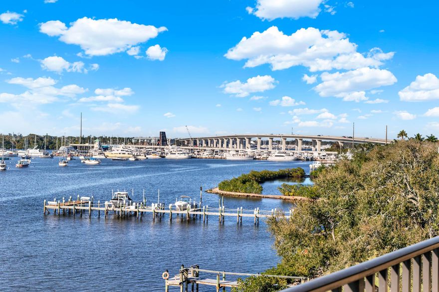 Highly sought-after Edgewater Condo, this beautifully appointed 2-bedroom + office, 2-bath residence offers timeless finishes and expansive SUNSET views over the St. Lucie River from a 45-foot balcony. Rich hickory wood floors extend throughout the home, complementing custom kitchen cabinetry and distinctive school-slate blackboard countertops. A separate laundry room includes a full-size washer, dryer, and utility sink for added convenience. The primary suite is a true retreat, featuring four closets and a refined bath with custom illuminated medicine cabinets. Additional highlights include a custom entry door, French doors, electric hurricane shutters, and electric sunshades. Enjoy riverfront living with access to a private marina offering slips for vessels up to 80'.