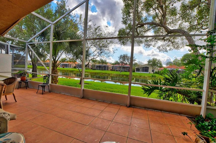 Come enjoy the relaxing water view from the extended screened patio with a lush tropical waterfall. Move right in to this Este model, which boasts an open split  floorplan and a desirable North  and South exposure. Large master bedroom and bathroom with a roman tub a separate shower and water closet. Accordion shutters throughout and a spacious 2 car garage and driveway.  Maintenance fees include cable, internet, lawn care . Also the community has an active clubhouse with resort style pool tennis and pickleball along with many other activities.