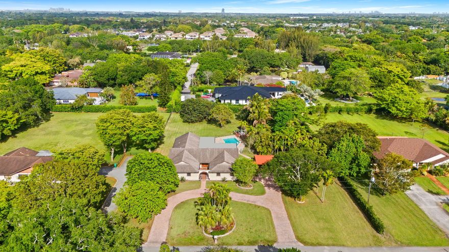 Situated on 1.17 acres in the heart of Davie, this beautifully updated residence offers the perfect blend of space, privacy, and modern comfort. Recent renovations include new flooring, a redesigned kitchen, updated laundry room, and a refreshed pool area. The home features a spacious open layout with a desirable split floor plan, ideal for both everyday living and entertaining. Additional highlights include a two-car garage, large circular driveway with covered carport, and an expansive backyard with endless potential. Conveniently located near top dining, shopping, and major thoroughfares.