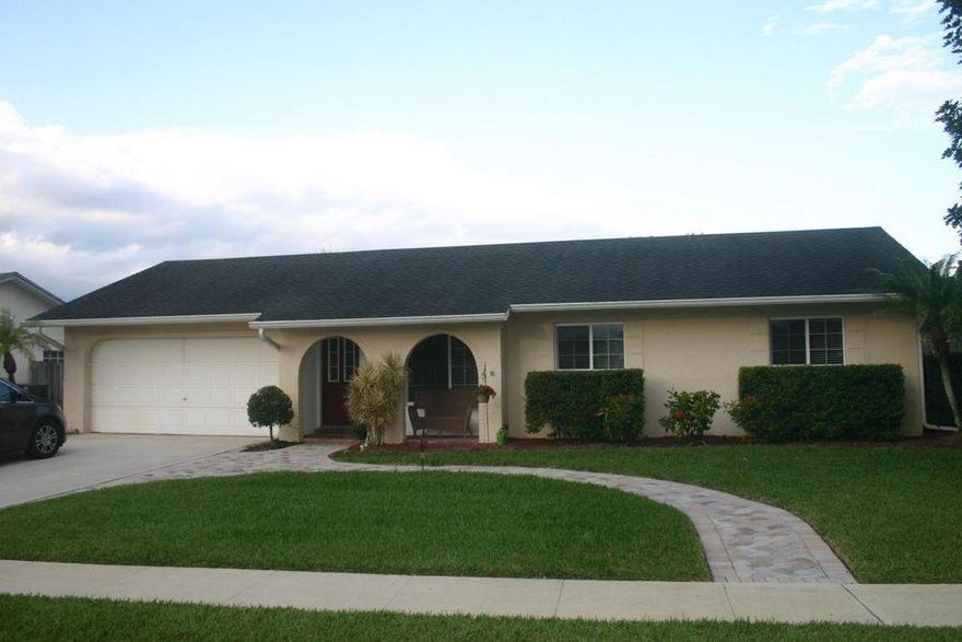 Beautifully updated with lovely architectural details throughout this 3 bedroom, 2 bath, pool home.  Fabulous kitchen with granite countertops, hardwood floors, crown molding, french doors, built-in shelving, large fenced back yard, GORGEOUS pool, spacious screened-in lanai...all in a central Wellington location in top notch A-rated school district. Wonderful neighborhood with playground, wide canal access to Lake Wellington perfect for the kayak enthusiast.  NO HOA! Quick closing available. Owners offering $2,000 CARPETING/PAINTING ALLOWANCE!!!