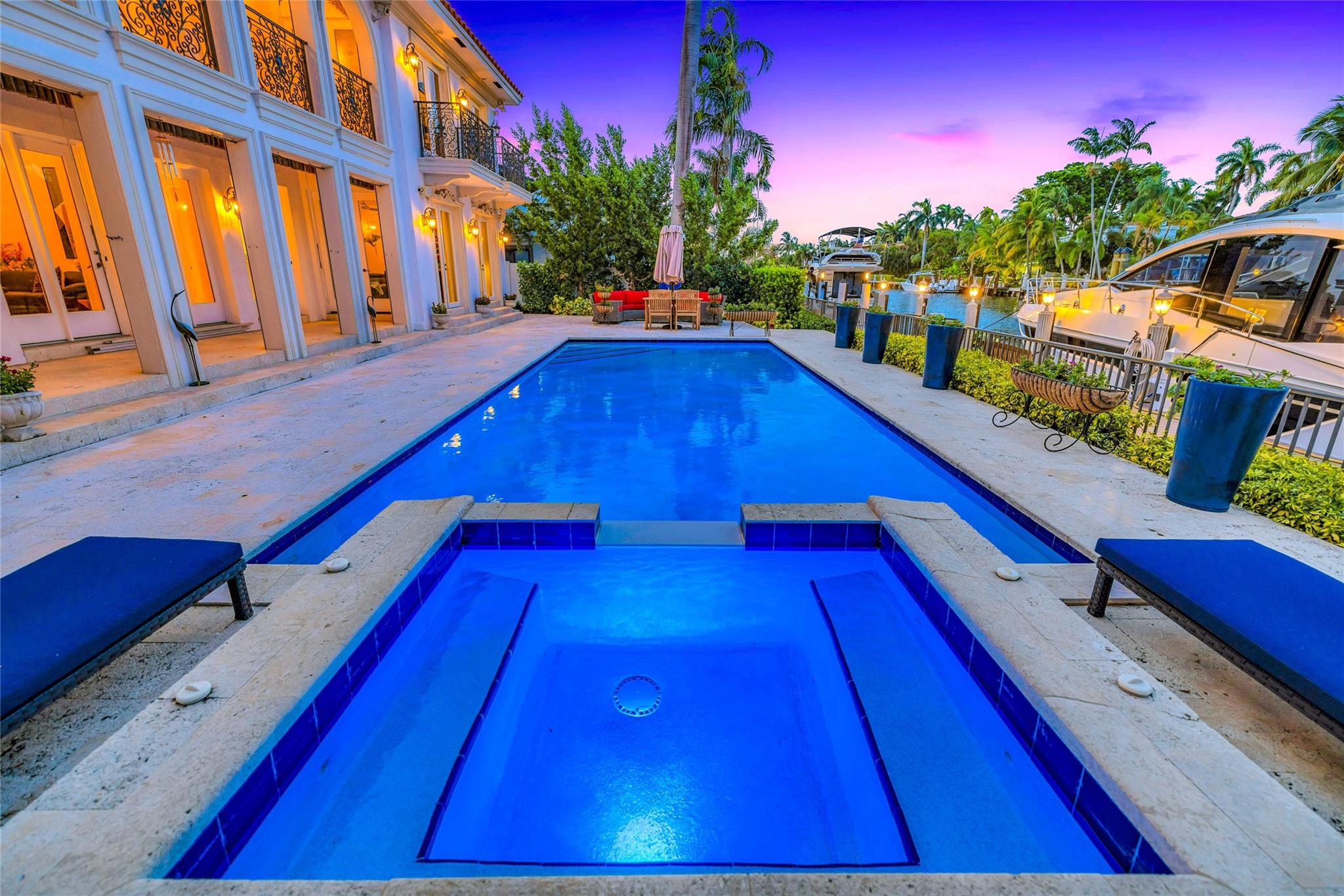 Step into refined elegance at this recently renovated, estate in Las Olas Isles, offering 5,000+ sq ft of timeless design on 85 ft of prime deepwater frontage. Grand marble floors and soaring ceilings lead to a gourmet chef’s kitchen with premium appliances and open-concept living spaces designed for upscale entertaining. The VIP guest suite, media/gym room, and richly appointed office (optional 5th bedroom) offer versatility. The lavish primary suite features hardwood floors, a spa-style bath, and custom walk-in closet. Outdoors, enjoy a Pecky Cypress loggia, resort-style pool, spa, and lush tropical gardens. New roof, 2 A/C units, and pool equipment.