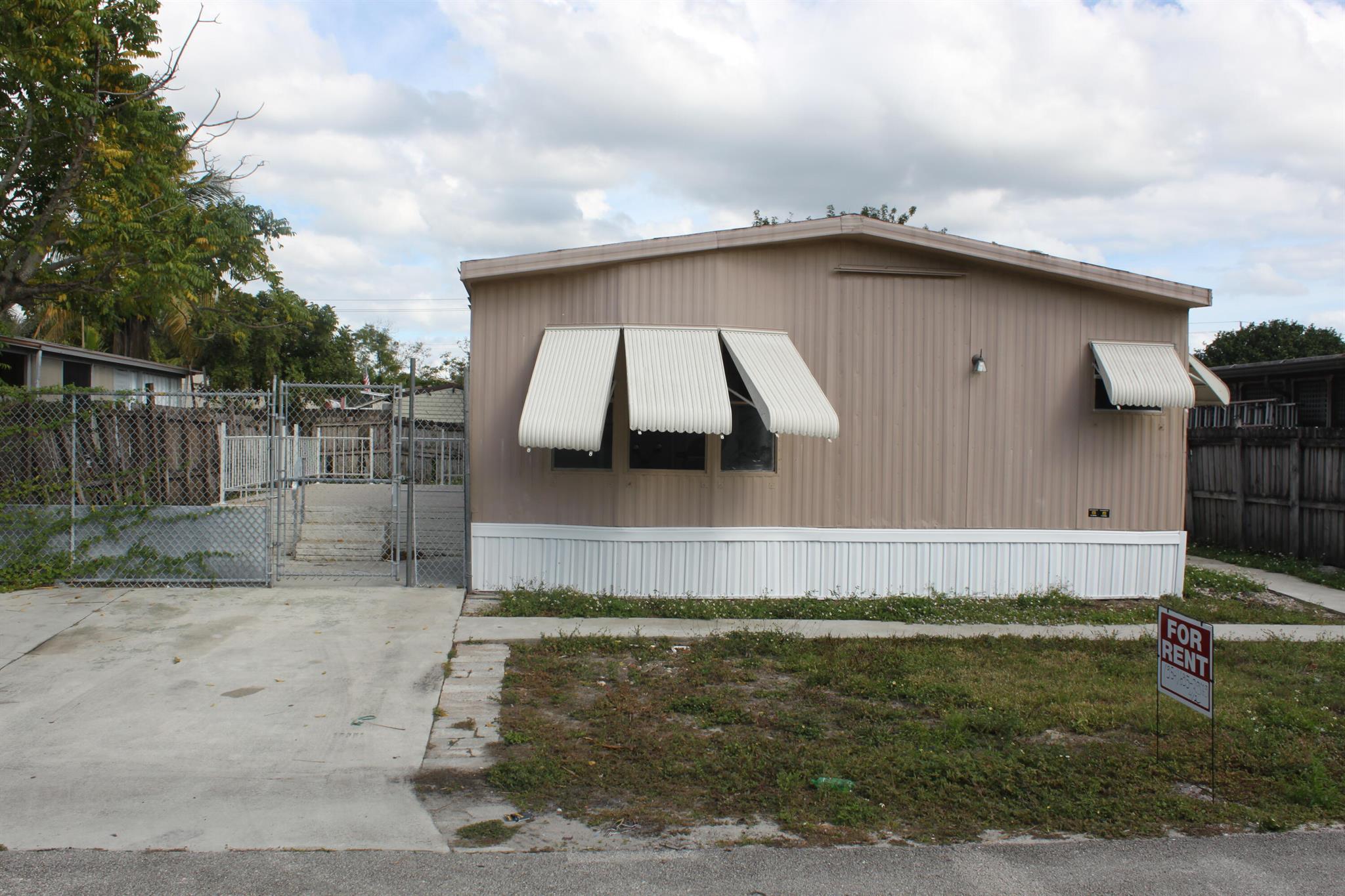 Great Location! 4/2 mobile home with open kitchen, granite countertop! New Roof! Private fenced yard, concrete porch and central AC! Most affordable place to live in Boca Raton for a big family! A- rated boca schools! Lawn care included!