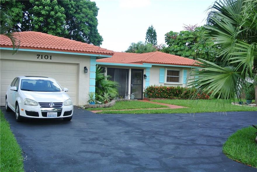 Fabulous 2/2 in Isles of Tamarac. Gorgeous landscaping, circular driveway and front porch. Home has 4 year old A/C.  Great open floor plan with open Florida room and separate back patio.  Large master bedroom with spacious closet. Tile and wood floors throughout and accordion shutters. Won't last!