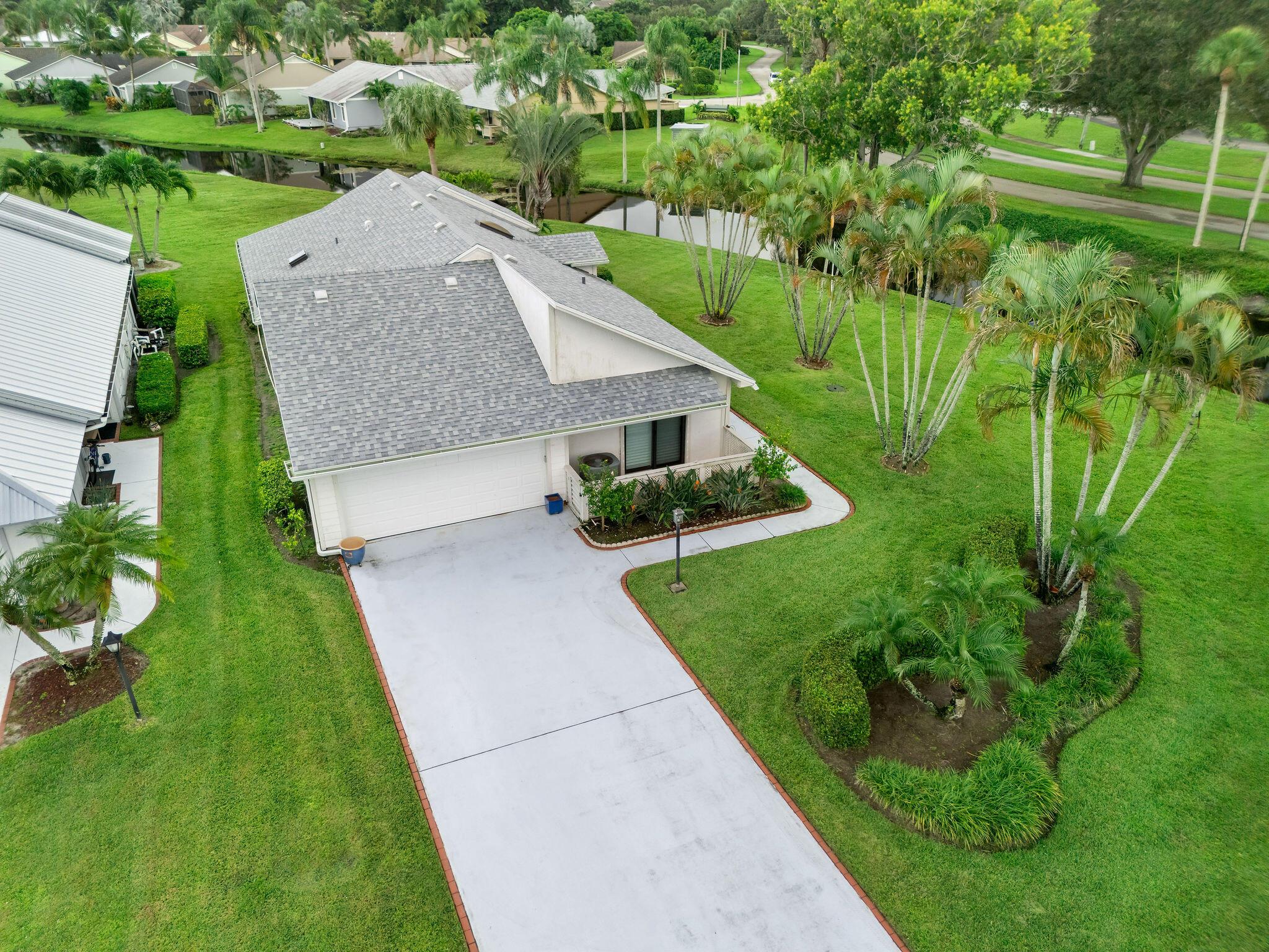Enjoy peaceful lake views from this well-maintained 3-bedroom home in Heritage Ridge North. Set on nearly one-third of an acre on a waterfront peninsula, the home features vaulted ceilings, Brazilian Cherry engineered wood floors, and an updated kitchen with wood cabinets and Quartzite counters. The spacious primary suite includes dual closets and access to the screened patio. Recent upgrades include a 2021 roof, 2024 impact windows and doors, NEW kitchen appliances, new garage door, and a whole-house generator with an underground propane tank. The community offers a pool, tennis, pickleball, and golf options. Close to parks, beaches, shopping, and dining.