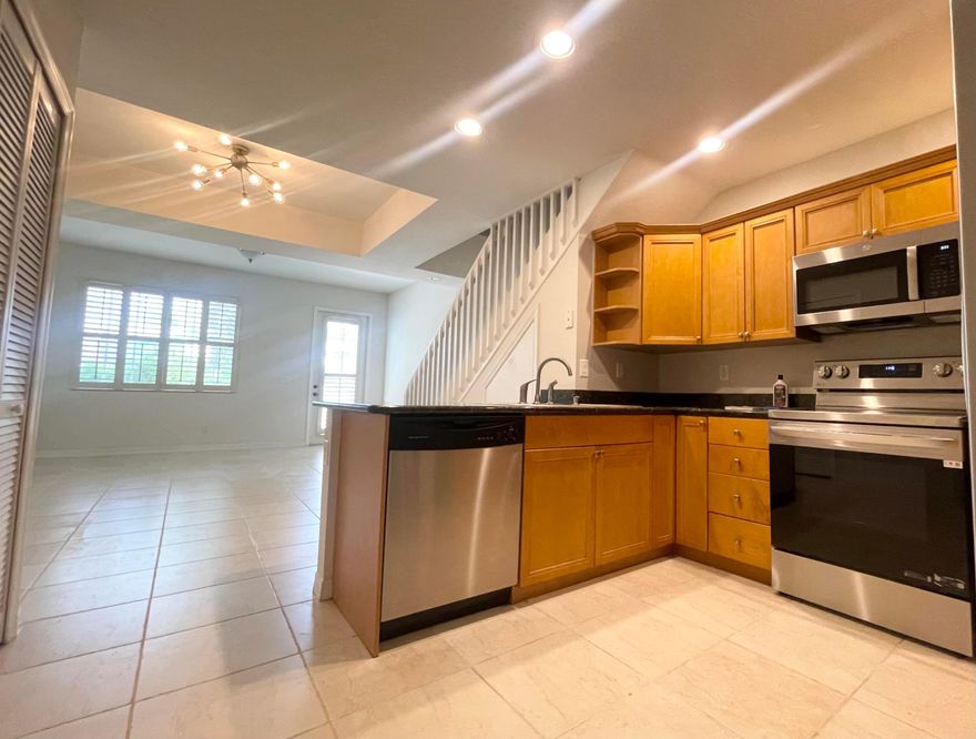 Live just minutes from the beach in this charming Key West-style 3BR/2.5BA,1‑car garage TOWNHOUSE, located in Pineapple Village South. The kitchen features wood cabinetry, a pantry, granite countertops, and BRAND NEW stainless‑steel refrigerator and stove. Upstairs bedrooms include impact windows for added peace of mind, and the home offers beautifully upgraded bathrooms, ceramic tile throughout the first floor (and even the garage), plus bamboo flooring on the stairs and upper hallway. Plantation shutters throughout add a clean, coastal touch, and a central vacuum system provides extra convenience. Pineapple Village South is ideally situated, between Lake Worth and Lantana beach, 10‑minute walk to  Intracoastal park, restaurants, shopping.