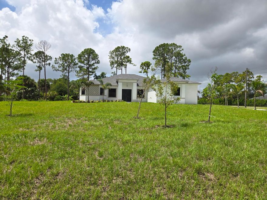 Brand-new construction in the heart of Loxahatchee! This beautifully designed 5-bedroom, 3-bathroom home sits on a large corner lot on a paved main road with NO HOA. Offering 2,714 sq. ft. under air and 3,790 total sq. ft., the home features an open, functional floor plan, modern finishes, spacious living areas, and abundant natural light. The expansive property offers room for boats, RVs, toys, animals, or future additions. Conveniently located near major roads, shopping, dining, and top-rated schools while still offering the privacy and lifestyle Loxahatchee is known for. Information provided by builder and must be verified by buyer. Welcome to this stunning brand-new construction home in the heart of Loxahatchee! Situated on a large corner lot along a paved main road, this beautifully designed 5-bedroom, 3-bathroom residence offers the perfect combination of modern luxury, space, and freedom — all with NO HOA. Boasting 2,714 square feet under air and 3,790 total square feet, this spacious home features an open and functional floor plan ideal for both everyday living and entertaining. Enjoy high-end finishes, generous living spaces, and abundant natural light throughout. The expansive property provides endless possibilities with room for boats, RVs, toys, animals, or future additions. Conveniently located with easy access to major roads, shopping, dining, and top-rated schools while still offering the privacy and lifestyle Loxahatchee is known for. Don't miss this opportunity to own a brand-new home on a premium corner lot with no restrictions in one of Palm Beach County's fastest-growing areas.