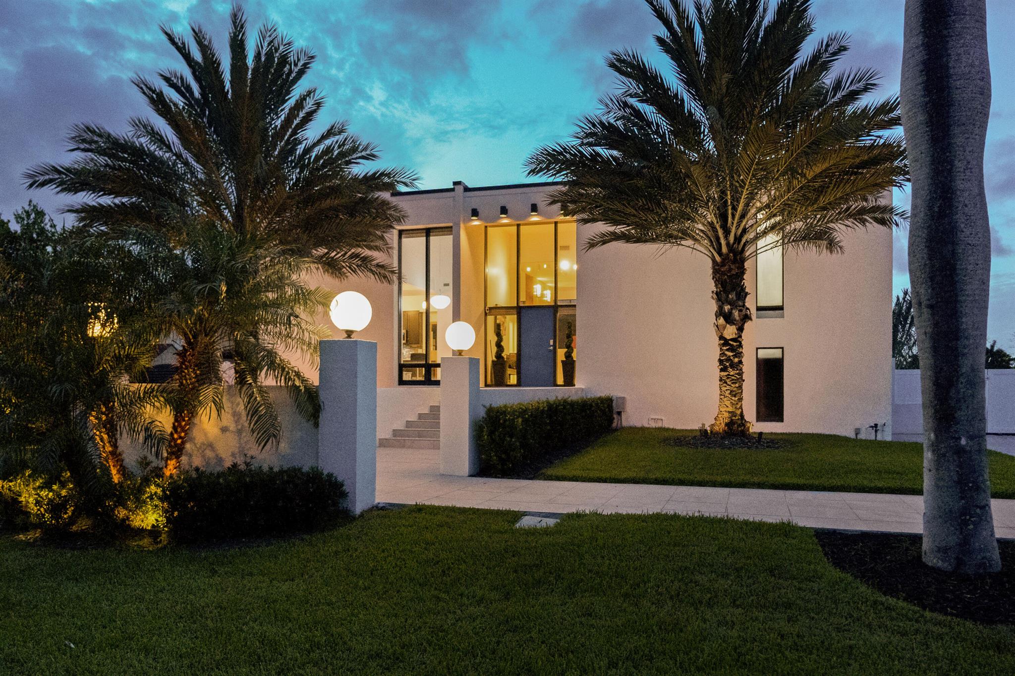 STILL SHOWING & ACCEPTING BACKUP OFFERS --- Welcome to this exquisite 4-bedroom, 2.5-bath contemporary home located in coveted Santa Barbara Shores, where panoramic floor-to-ceiling water views greet you from every room. This custom residence is a boater's paradise--set on 45 feet of water frontage, just 30 seconds to the Intracoastal, and a mere 9 minutes to the ocean. Enjoy a 35-foot concrete dock complete with a 15,000 lb hurricane-rated elevator boat lift, new concrete pilings, batter piles, floating jet ski dock and an integrated 26'' concrete cap seawall upgrade (2021). The dock is built to accommodate serious maritime enthusiasts, with fast-lift motors and step-across boarding ease. Situated on a lush waterfront lot, this 3,418 sqft home offers refined comfort and