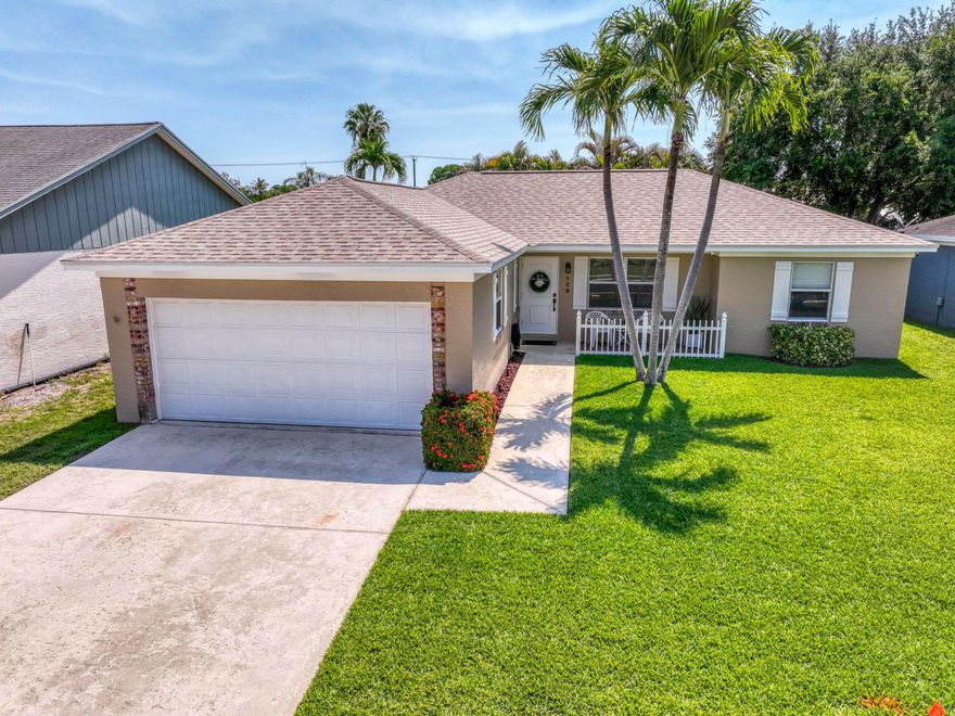 Whether you're starting homeownership, a family, or retirement- this home is the right one for you! Natural light and vaulted ceilings invite you in to this charming, updated property: three bedrooms and two baths of impeccably clean spaces lead to your backyard sanctuary - take a dip in the bubbly spa in screened protection, grill some steaks out on the pavered patio, and invite the kids and dogs to run around in the fully fenced grassy backyard. Completely protected with impact glass, roof replaced 2024, AC & water heater 2019. Very low HOA fee with the opportunity to opt into the community pool & tennis courts. The recently renovated Indian Creek Park and playground are an easy walk - 15 mins to the beach, 30 mins to PBI.