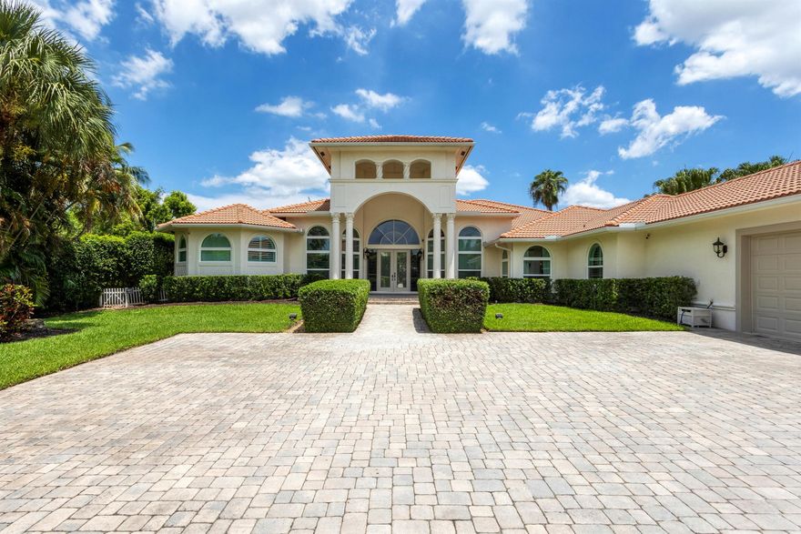 Experience exquisite luxury in this 5-bed, 3.2-bath South Florida estate, conveniently located near Atlantic Avenue, the Turnpike, Delray Marketplace, and beautiful beaches. Tucked away on a quiet cul-de-sac, enjoy unparalleled privacy on a sprawling 1-acre lot lined with verdant 12' hedges. The property boasts an expansive covered lanai, built-in summer kitchen, resort-style pool, and ample parking, idyllic for hosting. Step inside to a grand entrance revealing tray ceilings, custom wainscoting, Carrara floors, and state-of-the-art sound systems. A recently remodeled gourmet kitchen features quartz countertops, JennAir appliances, and a spacious pantry. The primary suite offers walk-in closets, an ensuite bathroom with a freestanding tub, and breathtaking views of the outdoor oasis.