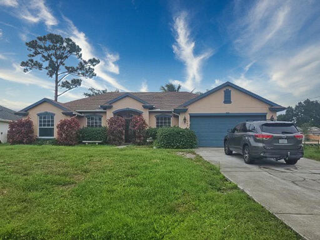 Photo of 1449 SW California Boulevard, Port Saint Lucie, FL 34953 (MLS # R10806807)