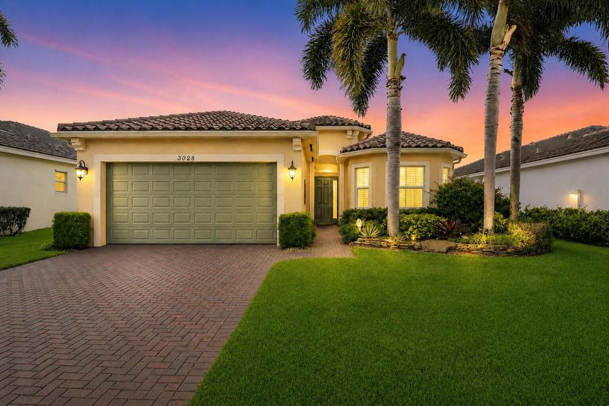This exceptional 3-bedroom, 2-bath residence is majestically positioned on an east-facing lakefront lot—one of the largest in the gated community of PortoSol offering refined South Florida living, breathtaking sunrise views, and an expansive setting rarely available. Thoughtfully designed with soaring ceilings and full impact glass, the home is filled with natural light, creating an open, airy atmosphere throughout the main living spaces. Meticulously maintained, the residence showcases a seamless blend of comfort and elevated design. The oversized kitchen is ideal for both everyday living and entertaining, featuring slab granite countertops and backsplash, custom cabinetry, designer lighting, and generous prep space—perfectly positioned to flow into the main living and dining areas. The  well-conceived floor plan offers a private primary suite retreat with a spacious bath and fitted walk-in closets, while two additional guest bedrooms are thoughtfully separated for optimal privacy. Step outside to an extraordinary outdoor setting with wide lake views and endless potential. The ultra-large homesite provides ample room to create a custom pool and built-in summer kitchen, transforming the backyard into a true resort-style oasis. The covered lanai enhances year-round indoor-outdoor living, capturing stunning eastern sunrise exposures. Recent improvements provide both style and peace of mind, including full impact glass and a sealed driveway and walkways. A two-car garage with high ceilings completes the offering. PortoSol residents enjoy a premier gated lifestyle with resort-style amenities including a clubhouse, pool, fitness center, tennis and basketball courts, playground, and scenic walking paths, social events all with low HOA fees. Ideally located in West Palm Beach, just minutes from shopping, dining, major commuter routes, and Palm Beach's world-class attractions.