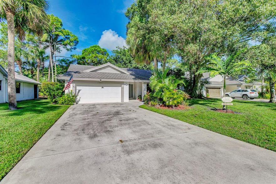 Rarely available CBS home in sought after Woodland Estates. Country feel in the city, Woodland Estates has beautiful mature trees, lake, pool and tennis courts. This 3 bedroom, 2 bath home is located on a cul de sac. Interior just painted and home is ready for a new owner. Cathedral ceilings, open floor plan and a fireplace in the living room. Roof was replaced in 2002, AC 2015. Close to great restaurants, shopping and beautiful Jupiter beaches.