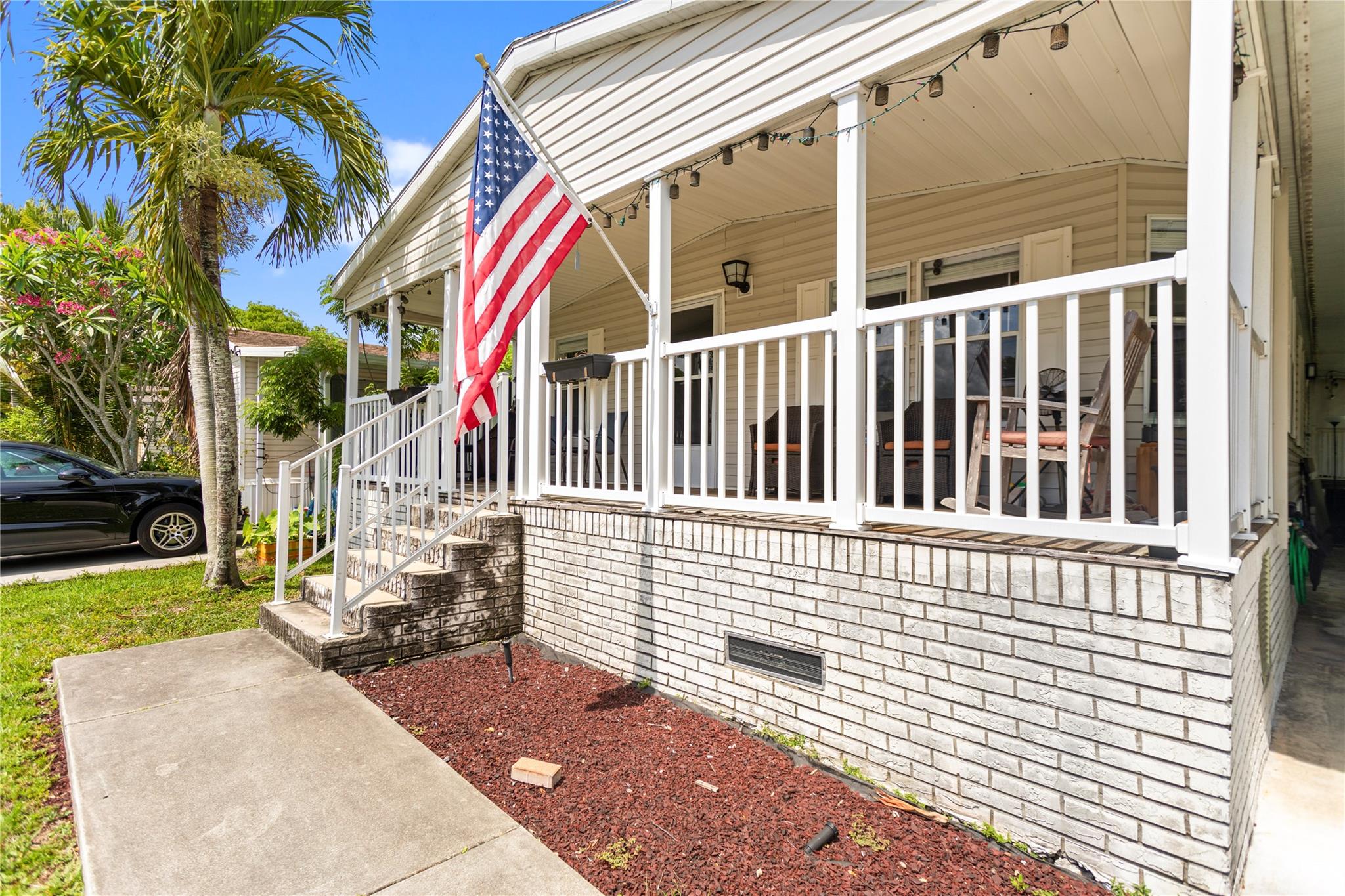 Beautifully updated 3-bed, 2-bath manufactured home with a welcoming front porch and spacious covered carport. Inside, enjoy an open layout with wood-like laminate floors and a remodeled kitchen featuring shaker cabinets, subway tile backsplash, oversized island, and stainless steel appliances (1 year old). A/C is 5 years old. The primary suite offers a walk-in closet, soaking tub, and separate shower. Separate laundry room inside. Outside, enjoy an extra-large storage area with potential to convert into an office just add a mini split! Land is leased through MHC Management for $1,100/month. Community features a pool, basketball court, and playground. Call today to schedule your private showing!