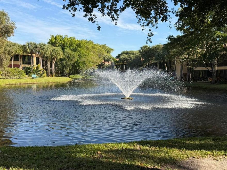 PHENOMENAL SETTING & VIEWS! Stunning, move-in-ready 2-bedroom, 2-bath condo. with wood floors and beautifully renovated kitchen and primary bath. Enjoy morning coffee in your serene and pristine sunrise water setting. Indian Spring is a private, secure, 55+ gated community. Open floor plan features nicely furnished dining, living, and Florida rooms, updated kitchen and a large private storage room, this home is offered furnished and ready for your immediate enjoyment. Newer washer & dryer. The optional membership country club, golf, tennis, resort-size pool, and restaurant at reasonable rates. Schedule a showing and experience Florida lifestyle at its finest. Conveniently located close to worship and just across from the the delightful community pool. Close to worship!