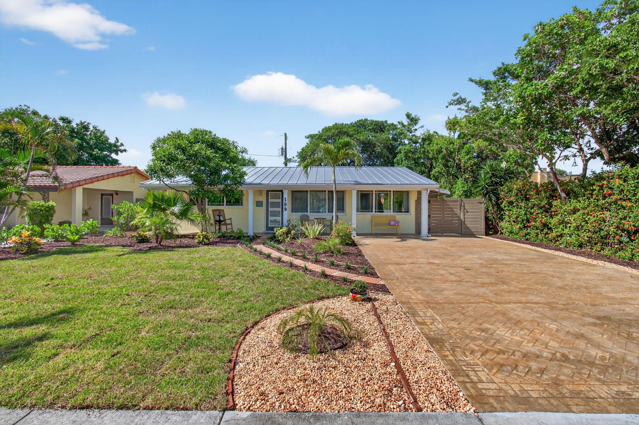 Welcome to 189 Harvard Drive, nestled in the heart of Lake Worth Beach's College Park Historic District. This charming single-story home offers 3 bedrooms, 2 full bathrooms, and a separate guest cottage, perfect for visitors, extended stays, or flexible living. A spacious 40-foot front porch greets you upon arrival, setting the stage for the home's inviting and relaxed vibe. Inside, you'll find an open layout in the main house, featuring a newly installed kitchen (2025) with 42-inch solid wood cabinets, dovetail drawers, and a soft, neutral color palette that suits any decor style. A covered porch off the back bedroom offers a peaceful spot to relax, while the screened-in enclosure off the bonus room provides the perfect place to unwind in the evenings.