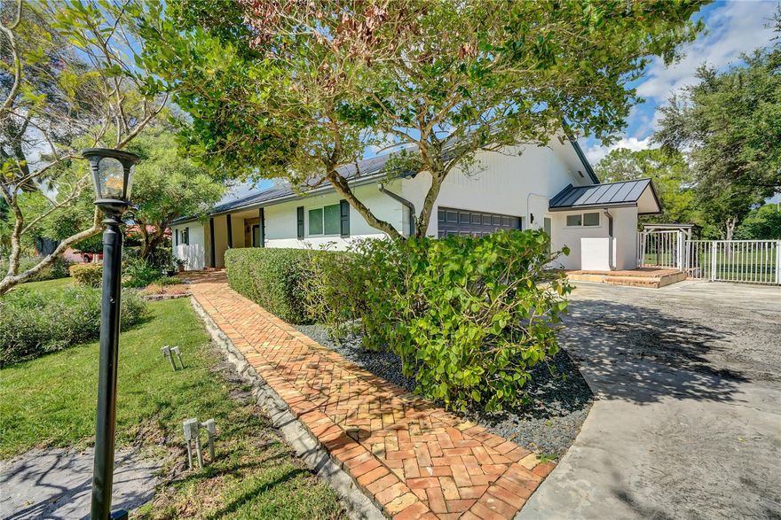 Beautifully remodeled 4-bedroom, 3-bath pool home on a peaceful canal-front 1.27 fenced acre lot in sought-after Southwest Ranches. This move-in-ready retreat features bright open living spaces, a stunning modern kitchen, and a spacious primary suite with pool access.  Beautiful trim work, chair railing, custom cabinetry and combo of travertine and real wood floors. Enjoy the ultimate Florida lifestyle with a huge Chicago bricked patio and private pool, expansive landscaped yard with avocado and mango trees, and tranquil water views. Perfectly located on a quiet street with easy access to I-75, I-595, shopping, dining, and top schools—offering the ideal blend of privacy, space, and convenience in one of South Florida’s most desirable horse friendly communities.