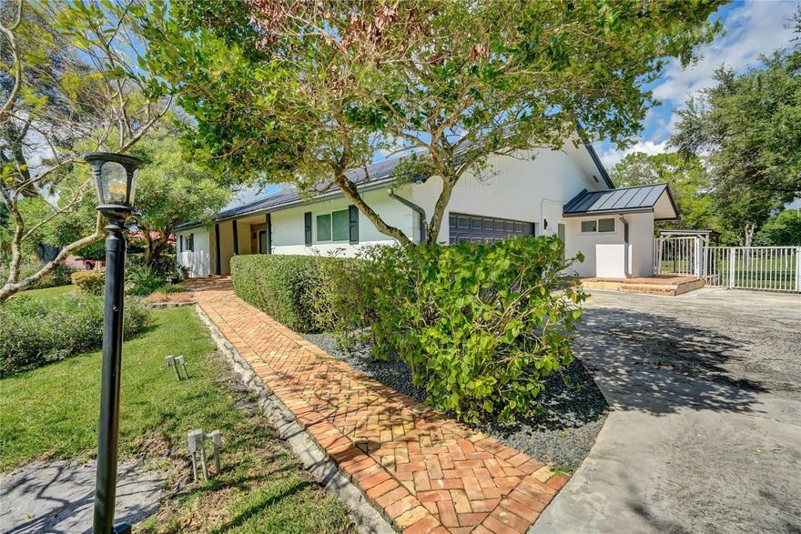 Beautifully remodeled 4-bedroom, 3-bath pool home on a peaceful canal-front 1.27 fenced acre lot in sought-after Southwest Ranches. This move-in-ready retreat features bright open living spaces, a stunning modern kitchen, and a spacious primary suite with pool access.  Beautiful trim work, chair railing, custom cabinetry and combo of travertine and real wood floors. Enjoy the ultimate Florida lifestyle with a huge Chicago bricked patio and private pool, expansive landscaped yard with avocado and mango trees, and tranquil water views. Perfectly located on a quiet street with easy access to I-75, I-595, shopping, dining, and top schools—offering the ideal blend of privacy, space, and convenience in one of South Florida’s most desirable horse friendly communities.