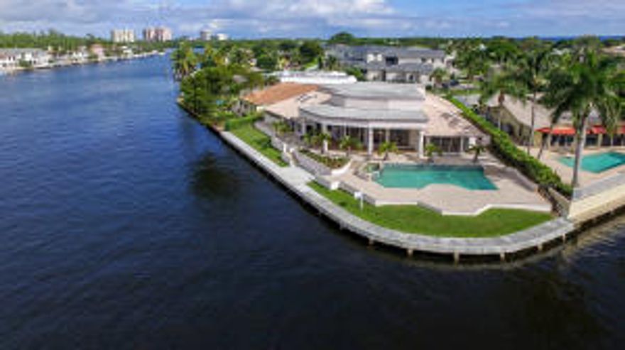 Rare Point lot located in the prestigious Sun & Surf Community in Boca Raton. The high vaulted ceilings, marble tile and stunning water views all throughout the home offer a serene living atmosphere minutes from restaurants and nightlife. On the exterior of the home an over sized brick pavered patio provides a tremendous amount of covered and uncovered outdoor living space. The home also offers a newly renovated seawall, motorized hurricane shutters on all openings along with a gas stand by generator.