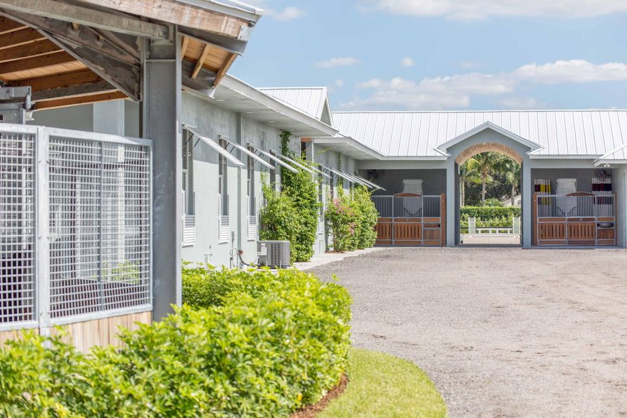 This superbly designed professional farm is situated on 6.25-acres in Saddle Trail Park and is just a short hack to the WEF show grounds. The main residence has three bedrooms, three bathrooms, and a great pool. The 30-stall center aisle barn is complemented by a large sub-irrigated (Riso system) ring with Martin Collins CLOPF footing, a new Grand Prix jumping field, lunging ring, and a six-horse covered walker.