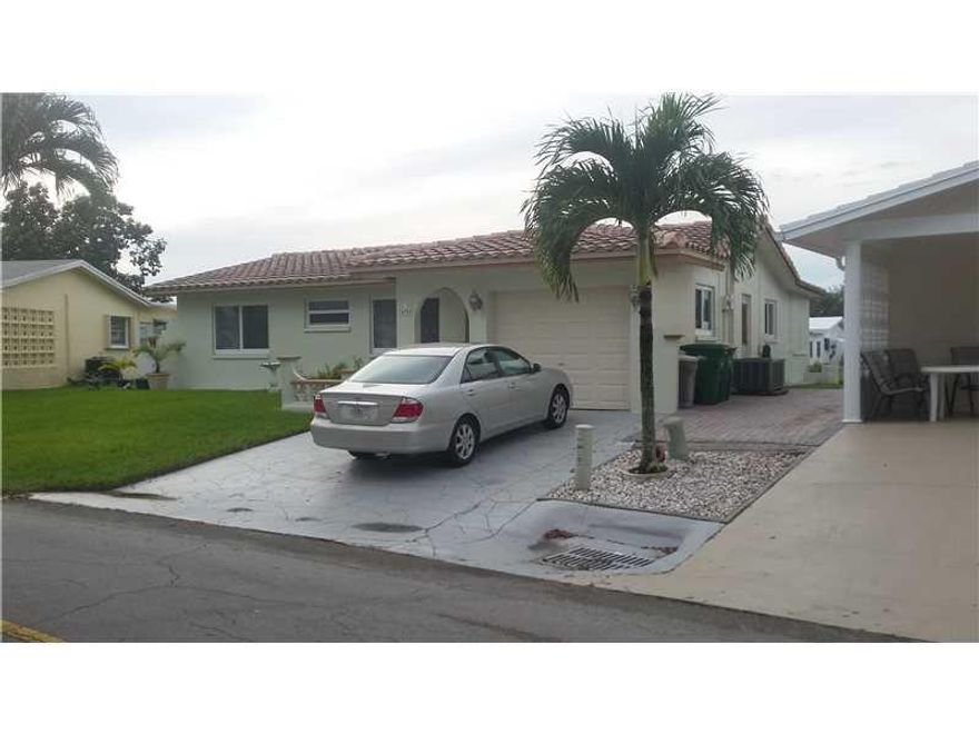 Absolutely beautiful water views in this impeccable 2/2 home in sought after Mainlands 1&2, Tamarac. Hurricane windows,barrel tile roof, garage, family room,and tile floors. Move in condition. Service policies on termites & bugs, garage door & A/C. Low ma intenance payment includes 2 pools (1 heated),clubhouse, sprinklers and total lawn care. HOA has good reserves. Close to great shopping and Turnpike entrance. Total area is beautiful and well-maintained. Bring your pets! This is a great place to live! 55+