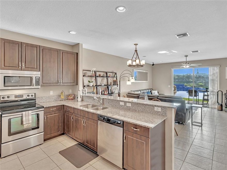 Nestled in the prime Davie neighborhood of Saddle Bridge sits this spacious 1408sqft 2/2.5 townhome close to great schools, parks, grocery/pharmacy, retail, restaurants, & more! The backyard offers a quite waterfront lake preserve minutes to highways (Turnpike/595/95/75). Home has all hurricane W&Ds and garage, 2020 A/C, lots of storage on both floors; custom built-in work benches, shelving, minifridge, and pully system in the garage; ceiling fans & recessed dimmable lighting throughout. Premium granite, whirlpool SS appliances, oversized glass shower in primary suite w/ two vanities, ceramic tile on first and in all baths, washer/new dryer 2021. HOA includes pest, landscaping, irrigation, upgraded pool, picnic, & playground. No pet or oversized vehicle restrictions!