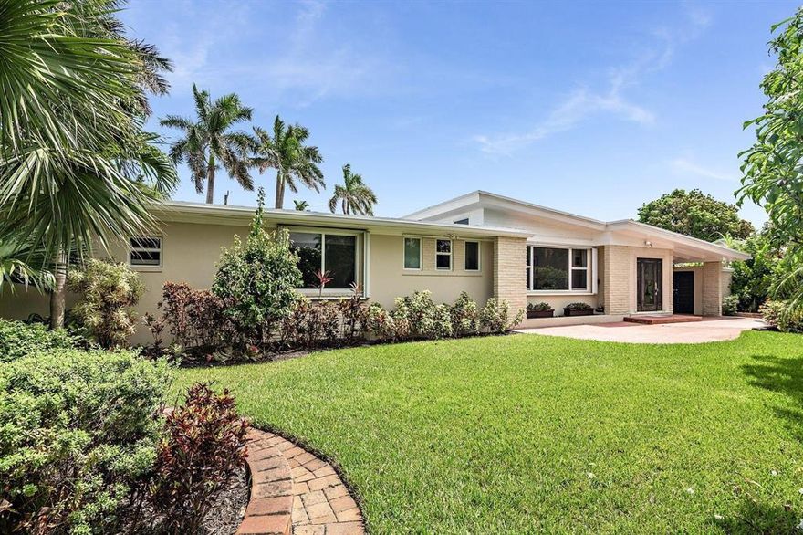 Private Oasis located in the most sought-after section of Northwood Shores. This updated 3BR/3BTH Midcentury Modern home has been meticulously renewed while maintaining its original integrity. Surrounded by privacy hedges, a brick paver courtyard welcomes guests. Formal entry foyer, impact windows & doors, gorgeous porcelain tile floors throughout, large 'window walls' bring in the outdoors & sunlight. Gourmet kitchen perfect for entertaining with gas stove, stainless steel appliances, refinished original cabinets & granite counter tops. Large open living area, super-sized bedrooms, mud room w/laundry, 3 full baths & carport. Gracious living continues out to two travertine patios with awnings overlooking a 42-foot pool, gas grill, newer roof, exterior lighting plus much, much more! Minutes to Palm Beach, Downtown and the now under construction Icon Marina Village.