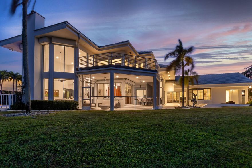 This contemporary masterpiece by renowned architect Randall Stofft brings Miami to Boca Raton!  A coveted GOLF MEMBERSHIP to Woodfield Country Club is available - NO WAITING LIST!!  Bright and light this home boasts over 6000 sq ft of zen-like living space with 5BD/6BA featuring volume ceilings and flow through views of the lake.  Enjoy this lake view from most rooms including the master bedroom, the Downsview highly functional and stylish kitchen with top-of-the-line appliances, the wrap around pool deck with heated pool and the 2nd floor Trex deck off a guest suite.  Artwork has a home here as well as there are many creative spaces and walls for display!  All 5 bedrooms are en-suite/possible 6th bedroom currently used as an office. A Must See - live your best Florida lifestyle here!