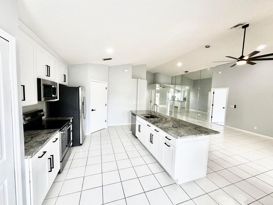 Single Family Home in River Bridge; a Guard Gated Community with all the Amenities you could hope for and a LOW HOA Fee: Clubhouse, Pool, Spa, Tennis, Basketball, Playground, and Sidewalks lined with Mature Oak Trees. This 3/2 home(used as a 2/2 plus Den) has an amazing Kitchen Remodel, including White Wood Soft Close Cabinets, 42'' Uppers, Stainless Steel Appliances and Granite Tops with Large Island, completed in late 2023, along with Interior Paint, New Ceiling Fans and New Door Hardware throughout. The home has Vaulted Ceilings, Tile Throughout, Recessed Lighting, an Enclosed Sun Room and a 2 Car Garage. Pets Welcome.