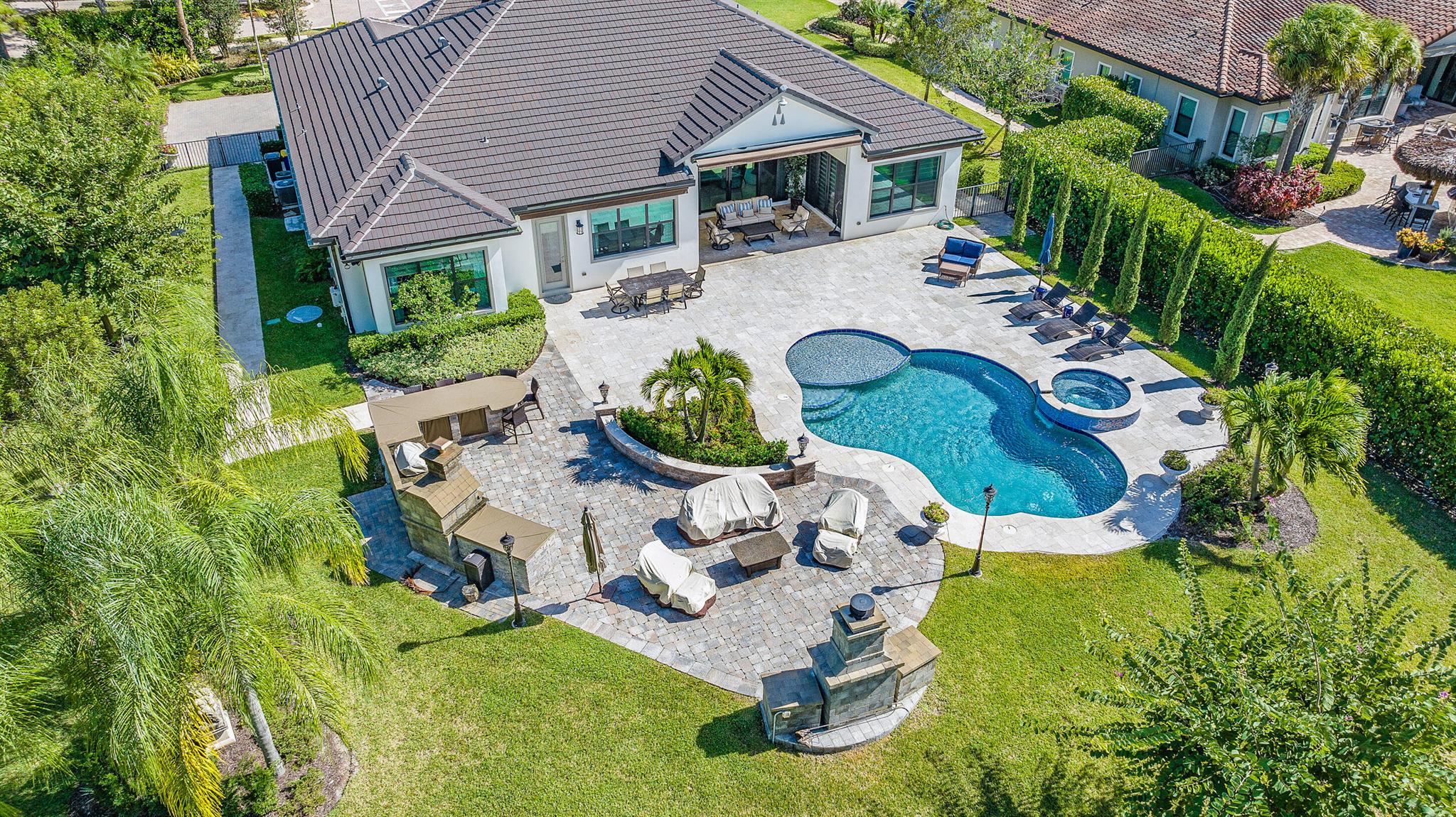Come stay in paradise!! The tranquil backyard is its own oasis! You will feel like you have your own resort living. This very spacious home offers 4 bedrooms, 5.5 baths, a Club Room, private Office. An open floor plan with gorgeous views of backyard and pool. Step down pool with spa. Outdoor has (3) awnings which extend remotely for additional shade. Club room has large TV, wine bar, and Treadmill. Split floor plan. Designer finishes and comfort through-out. 3-car garage. Cabana bath. Gated community, ADT system, impact windows. Come and enjoy true Paradise!!! Close to shops, restaurants, entertainment, beaches. Near I95 and Turnpike. (Season -Security $15k,13% Tax,, HOA Interview required. Elec includes up to $400/mth.)Annual rental available at $19k/mth includes Lawn, Pool, Water