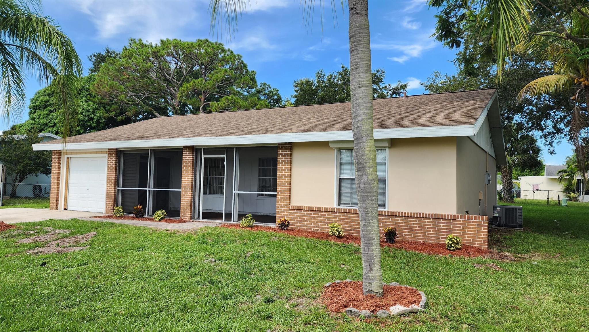This cozy 3-bedroom, 2-bathroom residence with a convenient storage space is perfect for comfortable living in central Port St. Lucie. Inside, you'll find tile flooring throughout, ensuring a clean and modern feel. Interior laundry room is easily accessible, making laundry a breeze. Paddle fans and window treatments add both functionality and style, while the open layout flows seamlessly, enjoy private time on your open patio, perfect for relaxation or entertaining. The partially fenced backyard provides privacy and room to enjoy outdoor activities. Located in a prime area, this home is close to shopping, schools, and just minutes from US1 and the Port St. Lucie Medical Center, offering convenience at your doorstep. Don't miss this opportunity to enjoy home ownership at its best.