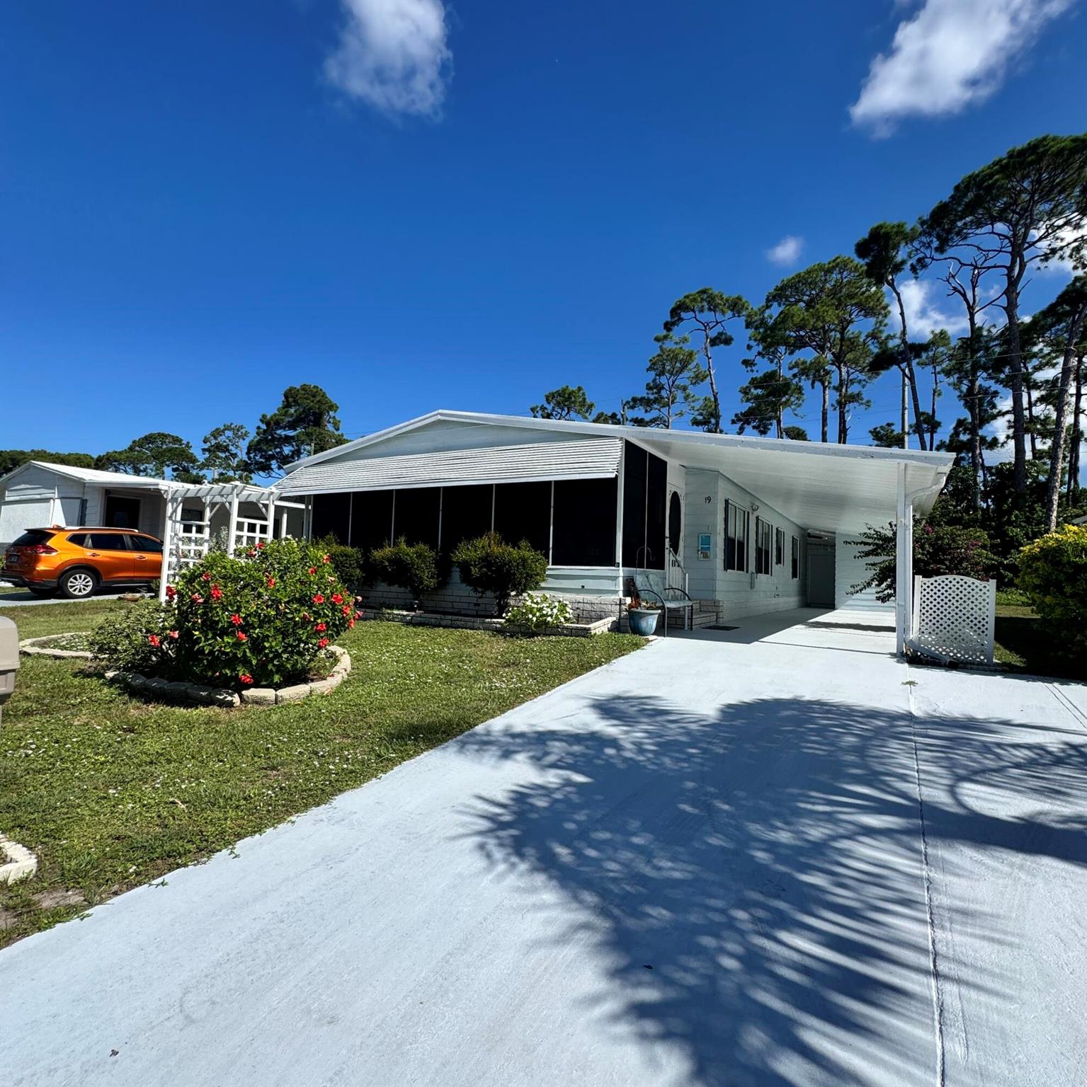 Lovely 2-bedroom 2-bath home in the desirable 55+Spanish Lakes Country Club community. This home has a spacious front Florida room. A den that can be used as an office or living room. The kitchen has granite countertops with an eat-in bar area. The dining room has two built-in shelves for added storage. This home has an extra-long carport as well as a shed. Home backs up to a wooded area for added privacy. HOME IS BEING SOLD FURNISHED AND IS TURN-KEY. NO CARPET! Lawn care, trash removal and golf included in lot rent.18-hole golf course, two pools, tennis, pickleball, bocce ball, shuffleboard, and much more. Must See!