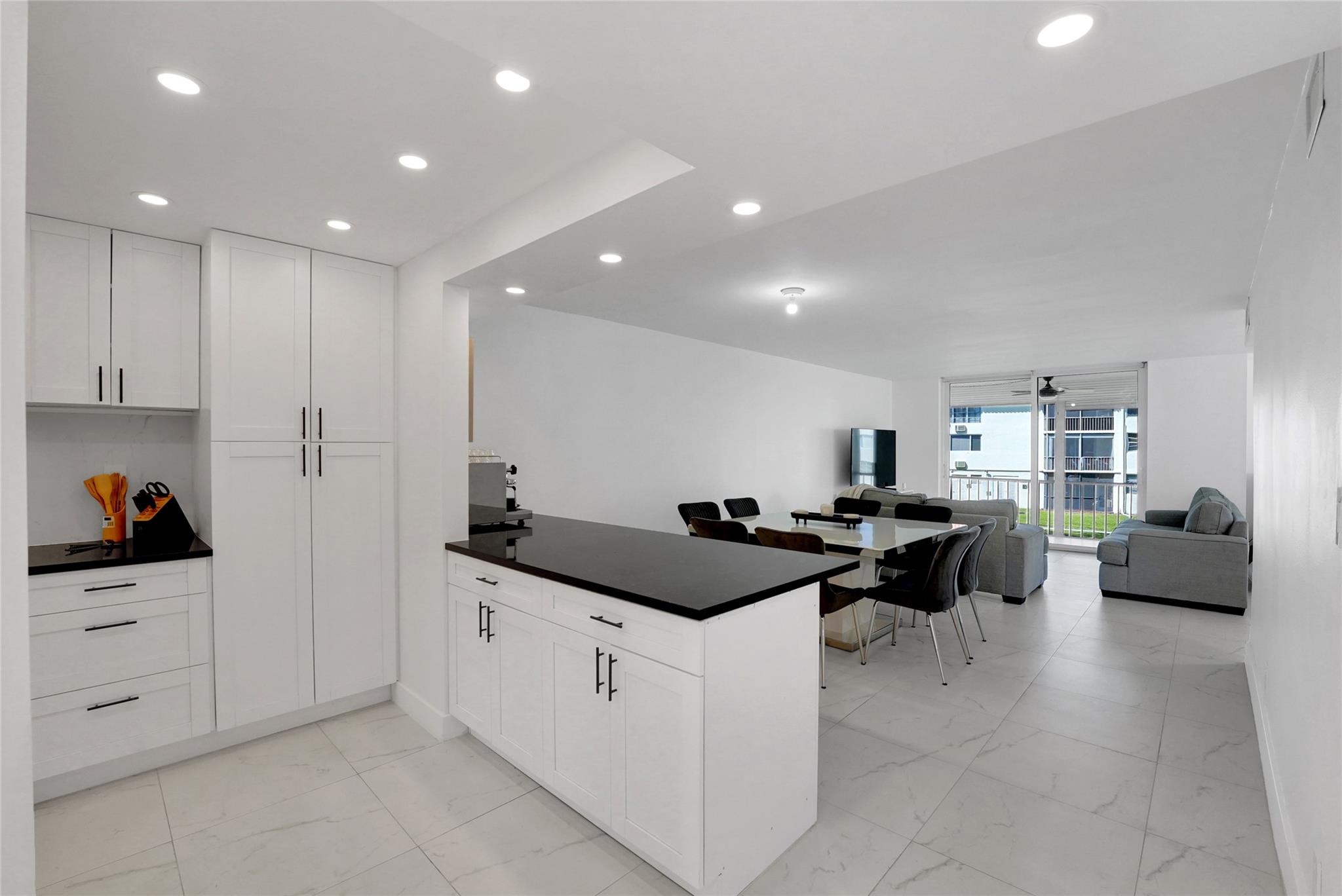 FULLY REMODELED ,ELEGANT, CORNER 2-bed, 2-bath condo in the highly desirable Hollybrook Golf & Tennis Club. Seller can assist with adding wall and door to enclose second bedroom if desired. The ULTRA MODERN look includes all impact windows and sliding door & a reinforced steel entrance door for added safety. The fully redone kitchen includes ample counter space and STAINLESS STEEL appliances. Fully furnished ( except for the coffee machine) this condo offers incredible amenities, including free golf on 2 18-hole courses ( cart fees apply), pickleball, tennis, heated pools, library, sauna, vehicle wash area, ELECTRIC CAR CHARGING STATIONS. Just minutes away from shopping & dining and 15 minutes from the beach.