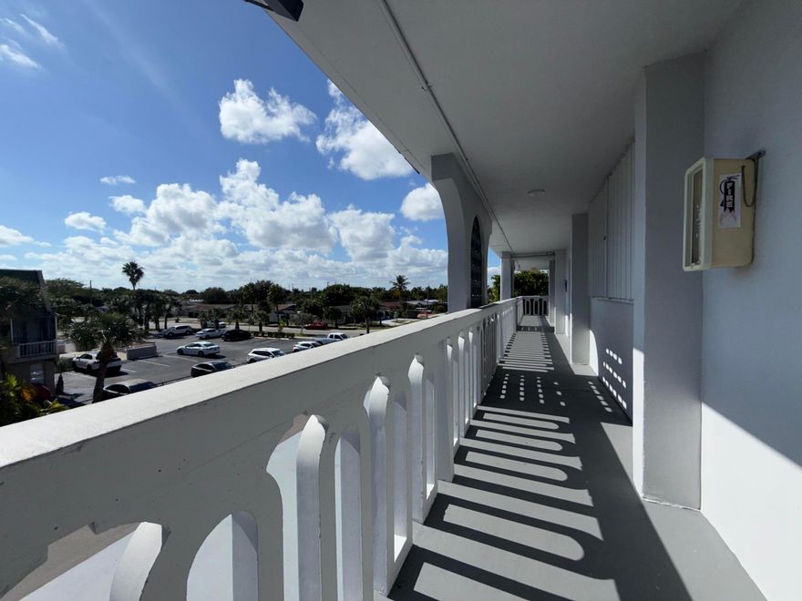 Bright 2 bedroom, 2 bath condo just a 2 mile walk or bike ride to the beautiful Atlantic Ocean. Walk to Sprouts Express for convenient grocery shopping. This unit features tile floors throughout, split bedroom floor plan and a screened balcony with northern exposure overlooking the pool and trees. New AC. Private storage for each unit, perfect for bikes and beach chairs. Includes one covered carport parking space. Enjoy easy South Florida living close to beaches, shopping, and restaurants. Located in a very walkable neighborhood (Walk Score approx. 77), with easy access to shopping, dining, and everyday conveniences.