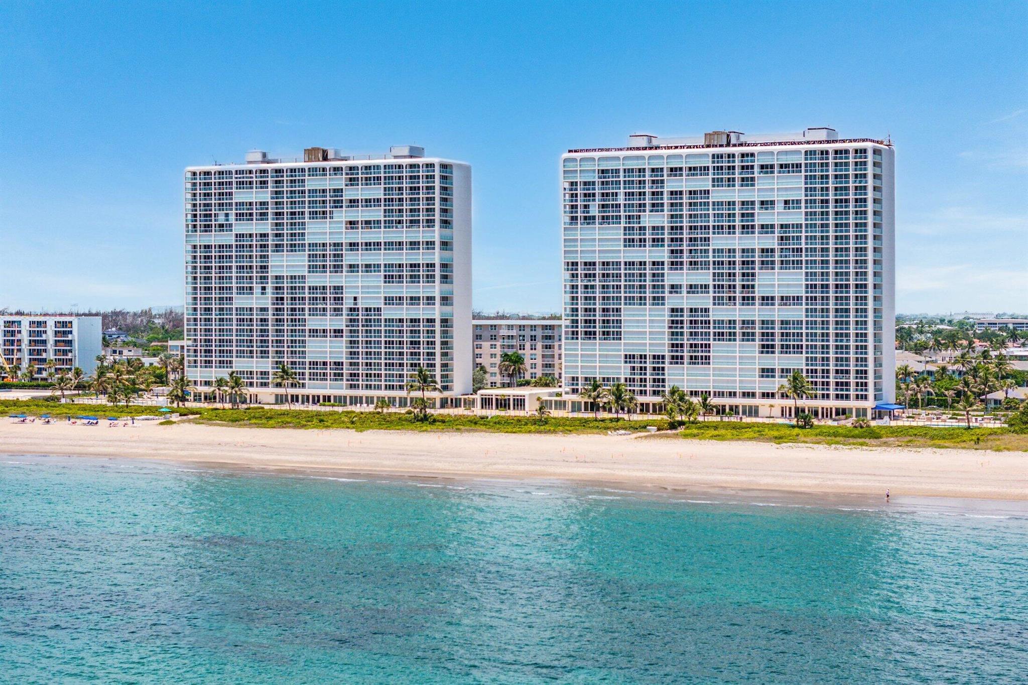 Experience luxury oceanfront living in this fully remodeled Ocean Towers residence! Tastefully updated with no detail overlooked, this condo is ready to enjoy. Large-format porcelain tile runs throughout, shining like the sun on the ocean. The kitchen features dolomite stone countertops, a spacious island with ample storage, and a pantry. Enjoy stunning ocean views from the living room, dining room, and kitchen.Spacious primary suite with two vanities and a walk-in closet. Unique floor plan includes a versatile bunk room, perfect for children or as an office, wine room, or additional closet space. Ocean Towers is nearing completion of an extensive modernization, including concrete restoration, new roofs, glass railings, and electric vehicle chargers. Milestone and Sirs completed!