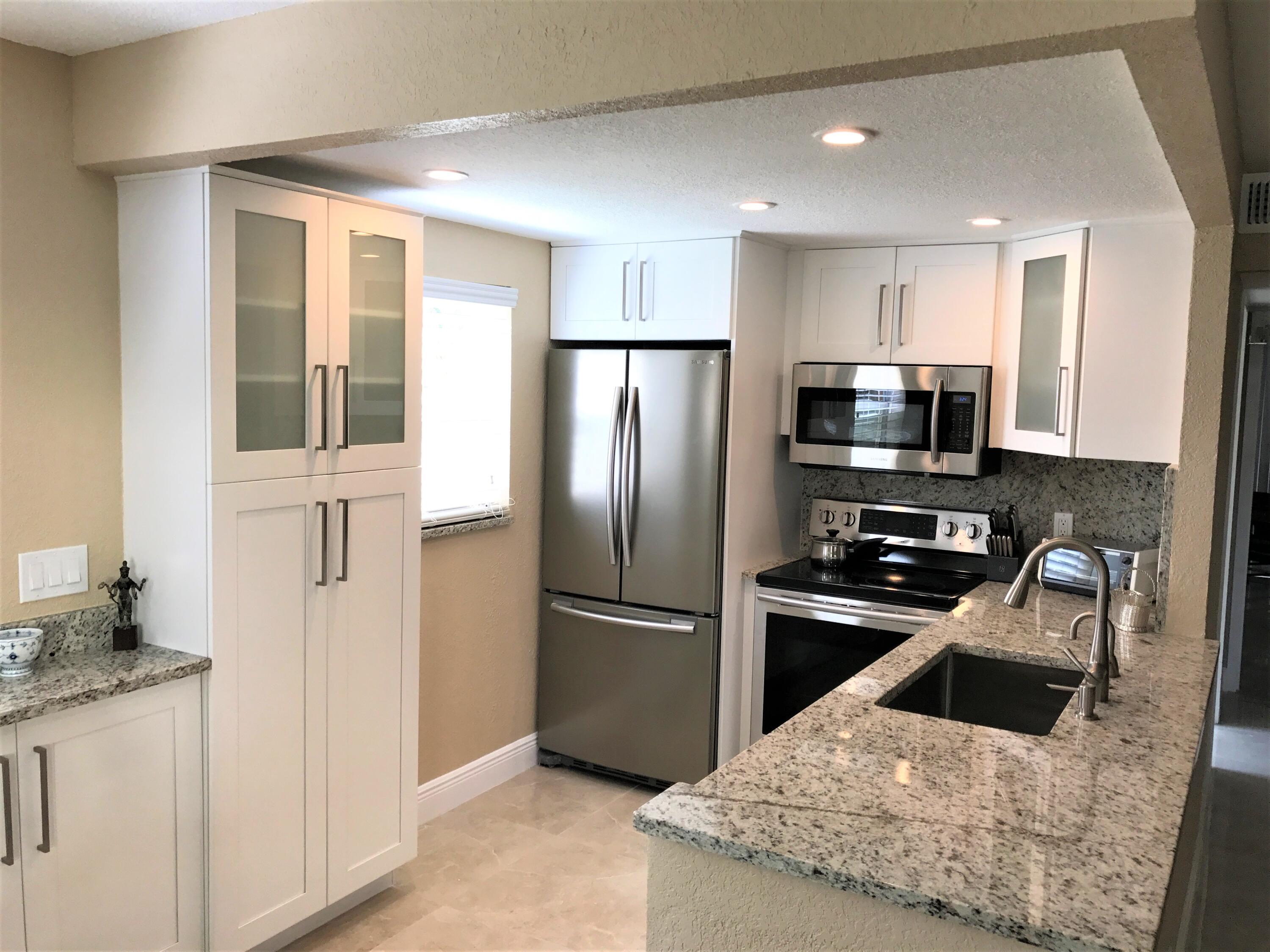 STUNNING, completely renovated, FIRST FLOOR 2 bedroom, 2 bath condo in sought after Kings Point with an enclosed patio, garden views, and a full size washer and dryer in an enclosed closet. This ANNUAL UNFURNISHED RENTAL has tile throughout, custom kitchen cabinets, granite countertops, stainless steel appliances, and unique, upscale bathroom vanities and fixtures. Assigned parking space close-by. 55+ community, guard gated w/security patrols. Many amenities including 2 golf courses, a huge clubhouse, theater, indoor & outdoor pools, restaurants, billiards, pickle ball, tennis and shuttle bus w. a nearby bus stop. Very close to the resident only Linton B'lvd. entrance.