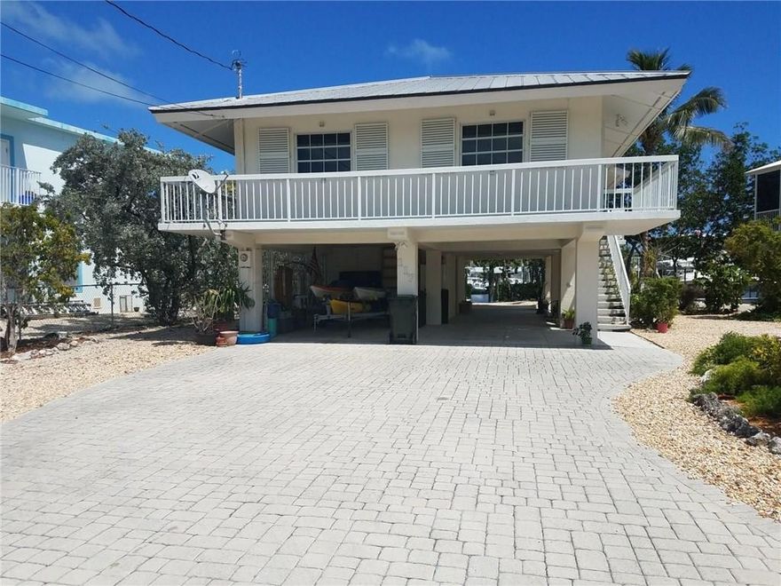 Rarely available waterfront home in Treasure Harbor.  Among the many features are: an upstairs washer and dryer, vaulted ceilings, new carpet in the bedrooms, fresh tile on the patio, a 35 ft dock made of  Epay (Brazilian hardwood) with two 30 Amp hookups, a working fireplace, a large screened patio upstairs and an open covered patio downstairs, a downstairs workroom that could be converted to a 4th bedroom/in-law suite, covered parking for up to 4 cars, and a fantastic view of Treasure Harbor.