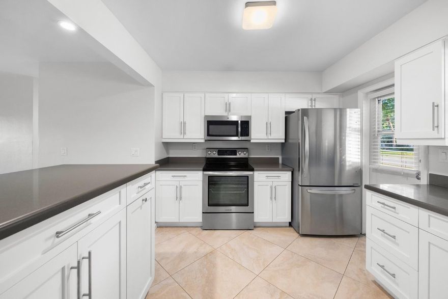 Beautifully renovated two-bedroom residence located in the serene surroundings of Venetian Isles. Recent upgrades within the last five years include stylish shaker kitchen cabinets, elegant quartz countertops, modern stainless steel appliances, a newer central air system, and 24" diagonal tiles throughout, among other enhancements. All age groups are welcome, and a small pet weighing up to 25 lbs is permitted. The convenience of this location is unmatched, with a brief stroll to Publix, nearby stores, and the library. Additionally, it provides easy access to Interstate 95 and the beaches. Residents thoroughly enjoy their time here, and vacancies are seldom available. Currently rented at $2050.00 per month. Lease ends 3/10/25.  This is a CO-OP. No financing is allowed per assiciation.