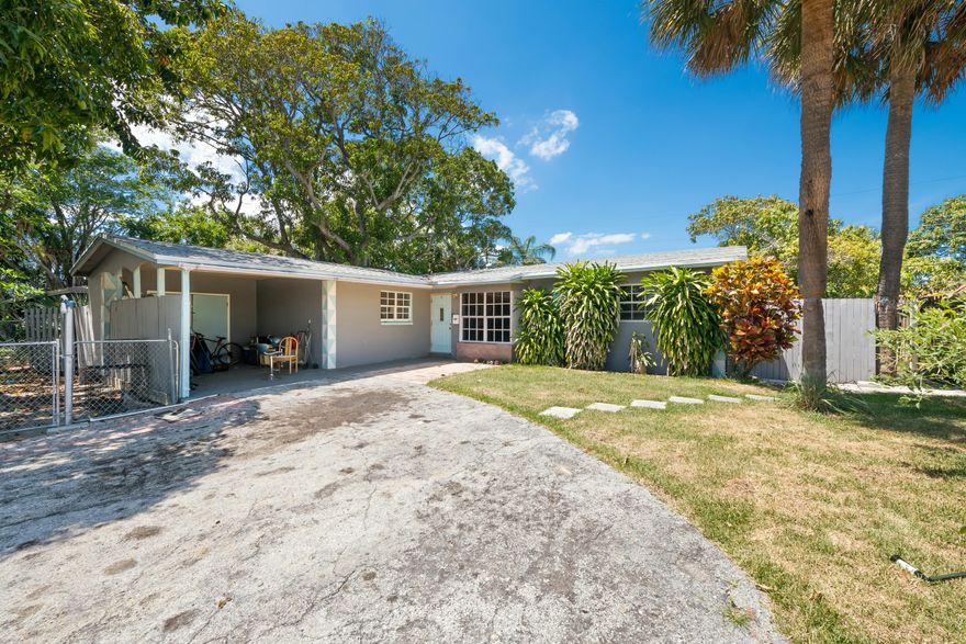 INVESTORS OPPORTUNITY! Spacious 4-bedroom, 2-bath fixer-upper with attached studio offering endless potential for investors, renovators, or buyers looking to create their dream property. This expansive home boasts over 7,000 square feet of living space and includes a convenient carport. With solid bones and plenty of room to customize, this handyman special is ready for your vision and TLC. Ideal opportunity to restore, redesign, or add value in a big way. Bring your imagination and transform this property into something truly exceptional!