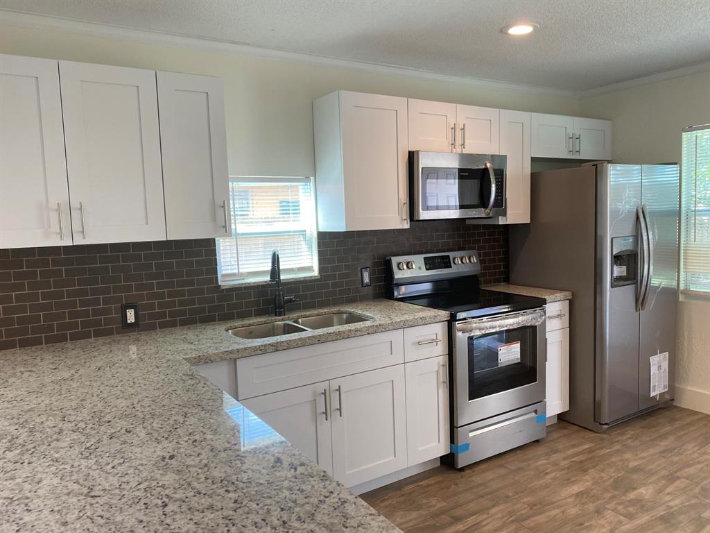 Beautifully renovated 3 bedroom 2 bath house.Tile throughout house, new kitchen with white cabinets and granite countertop, new stainless appliances, new bathrooms, impact windows and door, close to shopping, I 95 and beach, roof 2014, fresh paint in and out, ready to move in, fenced back yard with fruit trees, space for a pool