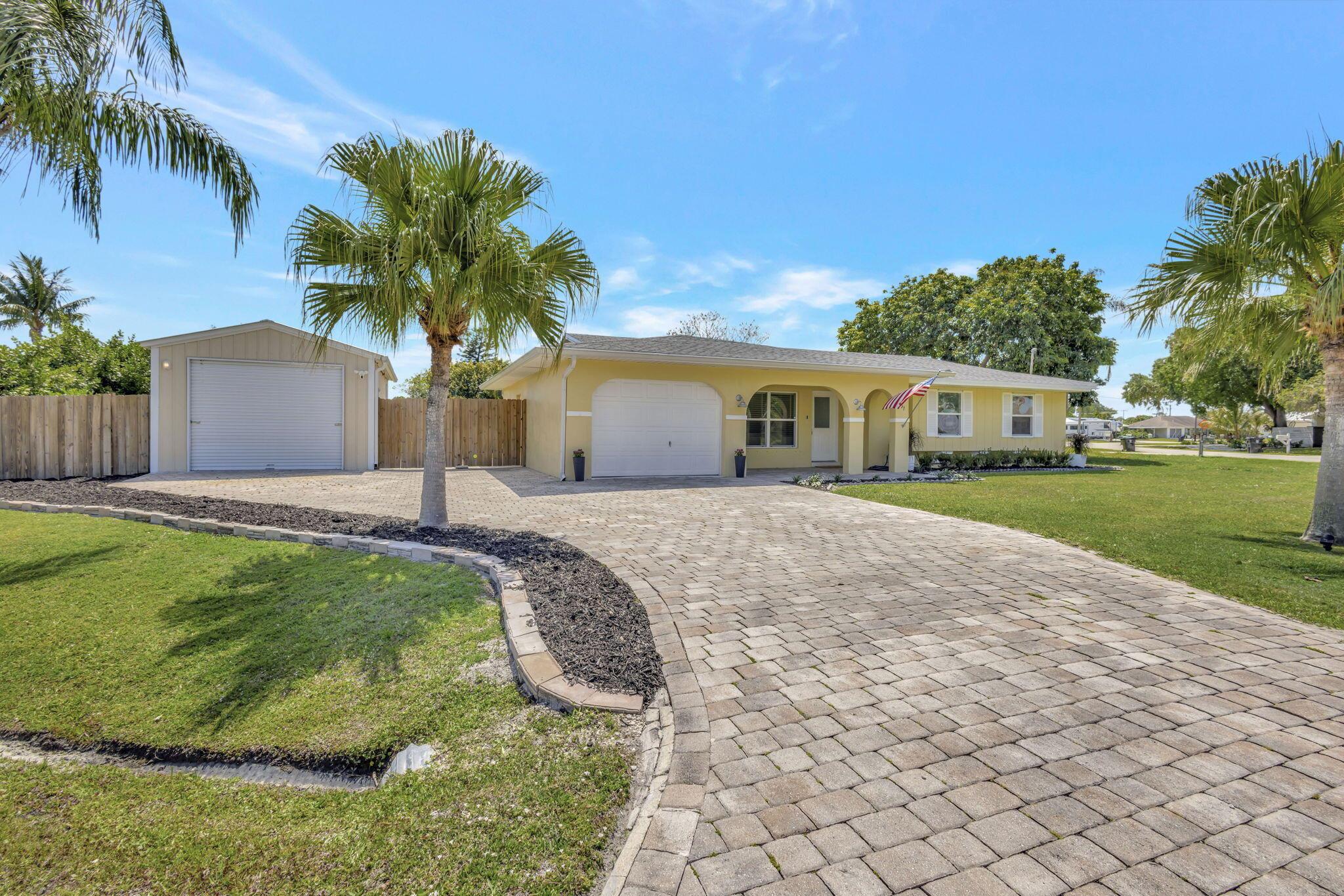 Great 3 bedroom 2 bath waterfront home on huge .4 acre lot with new roof (April 2024) and dockage for a 50 foot boat. Single car garage and separate outbuilding/workshop that could be a second garage. Room for a pool and to expand house footprint. Paver drive, screened patio, indoor laundry, nicely appointed kitchen, built in window seats in bedrooms, covered porch, tile floors. This house is cute and cozy and has huge potential. Fish from your own dock, and only a short boat ride to the inlet and ocean. Fix bridge clearance is 25 feet!