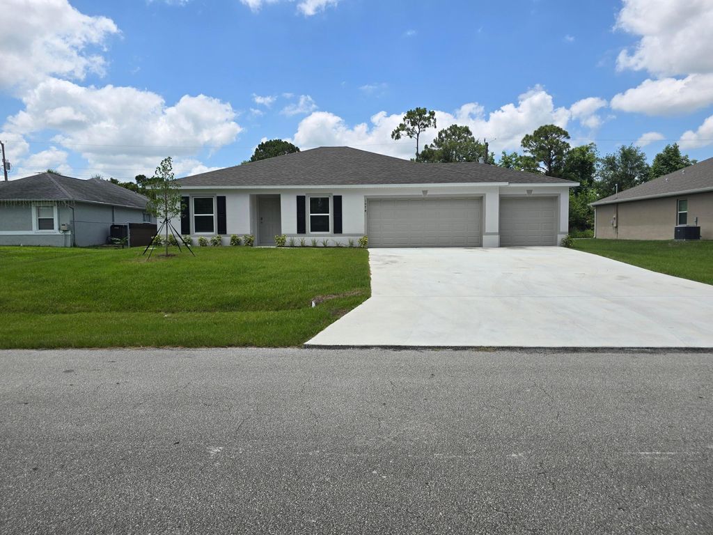 Photo of 1074 SW Calmar Avenue, Port Saint Lucie, FL 34953 (MLS # R11092388)