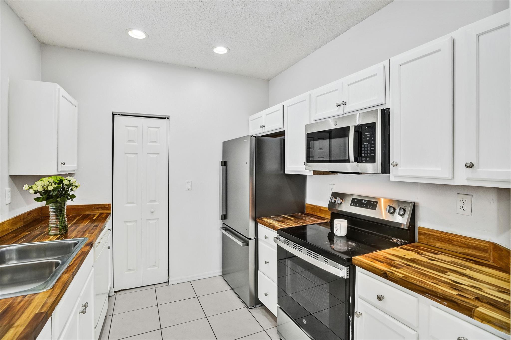 Motivated Seller! Welcome to Marbella Cove, a gated enclave within the desirable Waterstone community. This spacious 4BR/3BA townhome features rich espresso wide plank flooring-low maintenance,modern luxury, butcher block kitchen counters, volume ceilings, and a private fenced backyard with storage. Enjoy resort-style amenities including multiple community pools, clubhouse, gym, playground, and 24/7 security. Prime location near highways, hospitals, dining, and shops. LOW HOA. A perfect blend of comfort, style, and convenience.