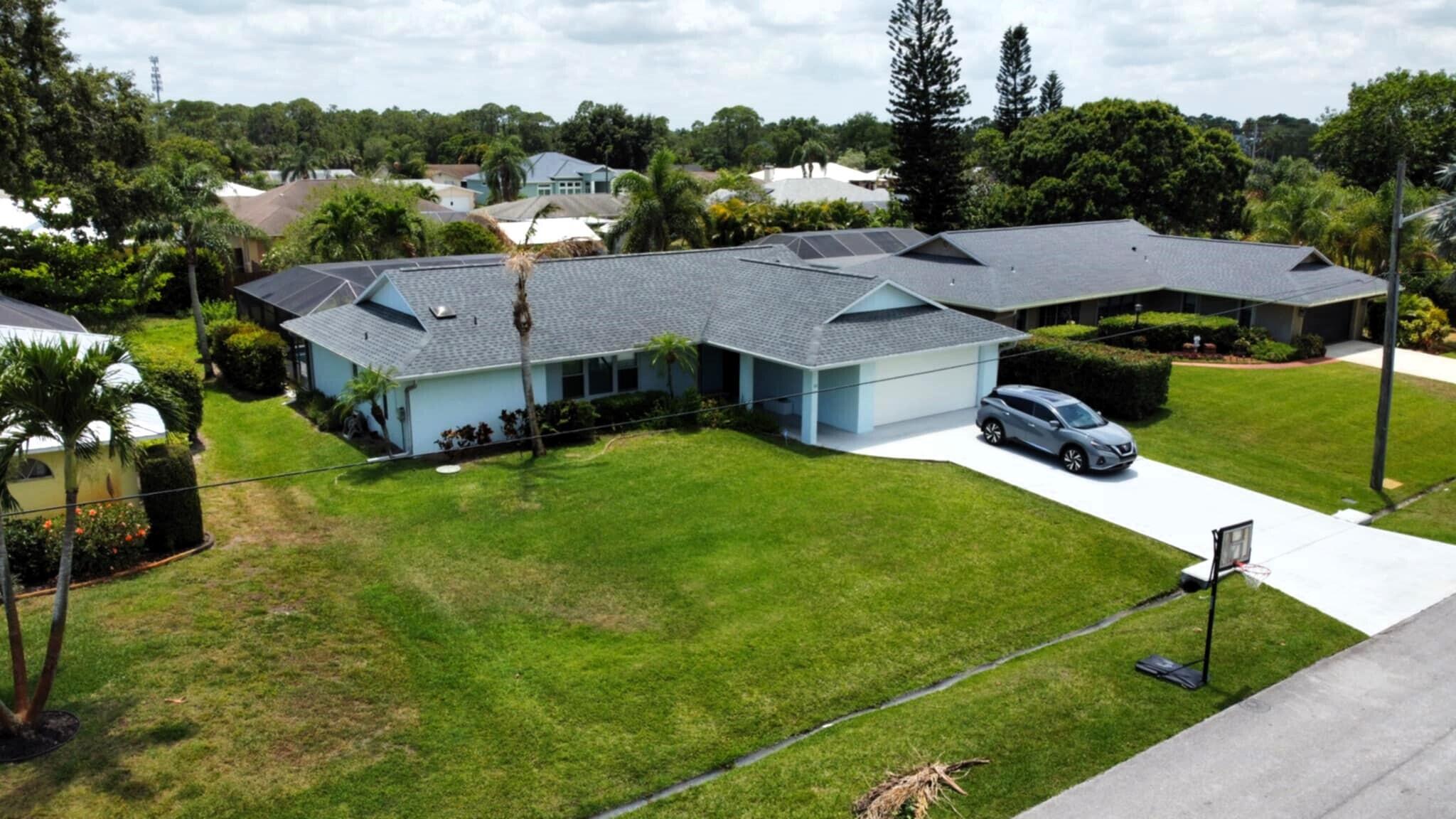 Welcome to your relaxing pool home at the heart of Sandpiper Bay area. With soaring ceilings, a split floor plan, beautiful wood floors in the living and master bedroom areas, impact grade windows + accordion shutters, all house generator with with a separate plug-in panel, instant propane gas water heater and pool heater, an automated 7 zone sprinkler system on well, and much more.. The newer 2021 roof and a CBS building construction ensure your lower insurance bills. Fresh exterior paint (2024), New Kitchen SS appliances (2025). Park your boat or RV: No HOA and not in a flood zone area. 7 minutes walk from the new PORT DISTRICT PROJECT with its extended river board walks, parks, botanical garden access and more! Port Saint Lucie resort-style living at its best! Come see it today!