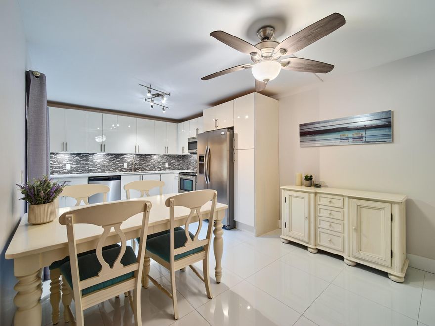 Immaculate, updated and completely move-in ready in the heart of Palm Beach Gardens - nothing left to do. Stunning and meticulously maintained townhome with a low HOA. Modern 24x24 white glossy tile flows throughout, creating a bright and open feel. The kitchen features acrylic white cabinetry, quartz countertops, Frigidaire Gallery appliances, and under-cabinet lighting. Open living area with a faux fireplace plus a first-floor office/den for added flexibility. Upstairs offers two spacious bedrooms and beautifully renovated bathrooms with stone countertops. The primary bath includes dual rain shower heads and multiple jet settings. New roof (2025) with assignable warranty, new stackable washer/dryer, tinted windows, and full storm protection. Custom closets, modern trim, doors, and smart outdoor lighting. Private fenced patio for relaxing or entertaining. Easy, low-maintenance living from day one - just bring your things and start enjoying!