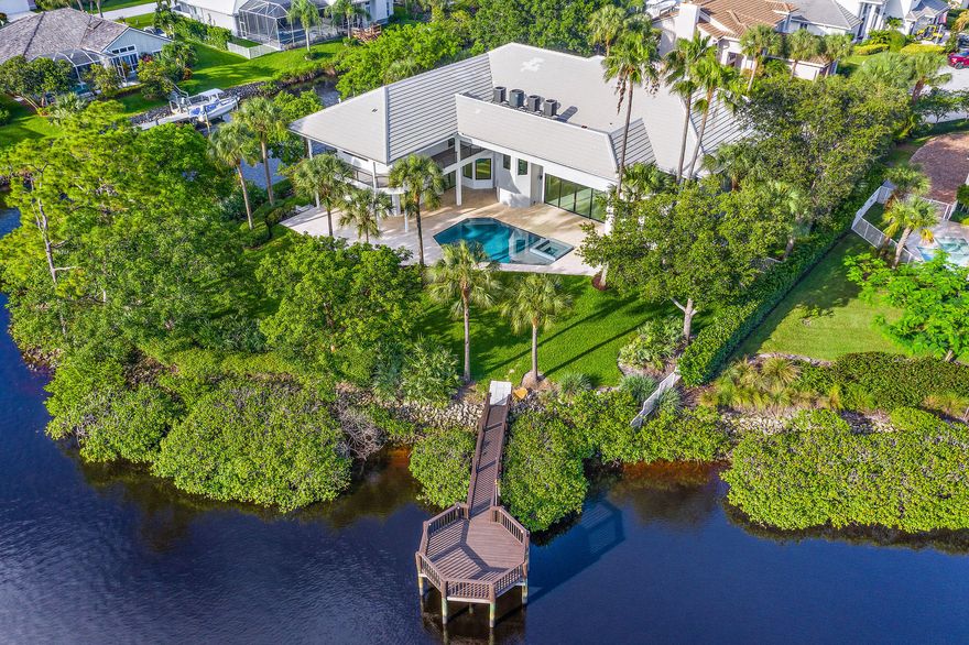 Fantastic Waterfront Home!  Spacious floor plan with incredible wide water views from nearly every room.  Gorgeous custom chefs kitchen with high-end appliances, two master suites and grand living areas great for entertaining.  Outdoor  living at its best with built in summer kitchen, pool and spa.  Private dock with boat lift and plenty of room for all your smaller water toys.  Easy access to the ocean!