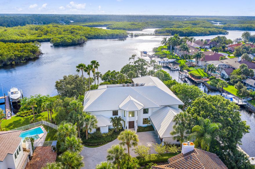 Fantastic Waterfront Home!  Spacious floor plan with incredible wide water views from nearly every room.  Gorgeous custom chefs kitchen with high-end appliances, two master suites and grand living areas great for entertaining.  Outdoor  living at its best with built in summer kitchen, pool and spa.  Private dock with boat lift and plenty of room for all your smaller water toys.  Easy access to the ocean!