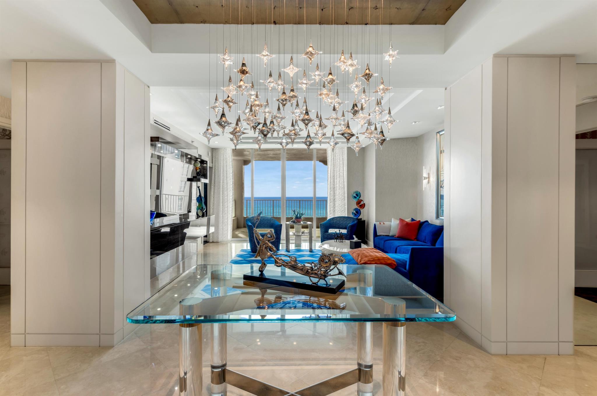 STUNNING 3 BEDROOM 3 BATHROOM AREZZO MODEL WITH COVETED GARAGE PARKING FOR 2 CARS AND AWE-INSPIRING VIEWS! FULLY REMODELED AND READY FOR IMMEDIATE ENJOYMENT! ELEVATOR ENTERS INTO A PRIVATE FOYER WITH DOUBLE GLASS-FRAMED DOORS. GORGEOUS SHADOW-REVEAL MILLWORK, LARGE-FORMAT MARBLE FLOORING, DOUBLE TRAY CEILINGS AND DESIGNER-CURATED WALL COVERINGS. CUSTOM-DESIGNED LIVING ROOM OPENS TO PANORAMIC OCEAN VIEWS, WHILE THE DINING ROOM FLOWS SEAMLESSLY TO AN INTRACOASTAL-VIEW BALCONY. GOURMET KITCHEN WITH CUSTOM CABINETRY, UNDER-LIT QUARTZ COUNTERTOPS, TOP-TIER APPLIANCES INCLUDING WINE AND BEVERAGE REFRIGERATION, AND A SPACIOUS PANTRY. THE SPLIT BEDROOM LAYOUT ENSURES THAT EACH ROOM IS SEPARATELY PLACED FOR OPTIMAL PRIVACY. LUXE PRIMARY SUITE WITH DUAL CLOSETS AND A SPA-LIKE PRIMARY BATH.